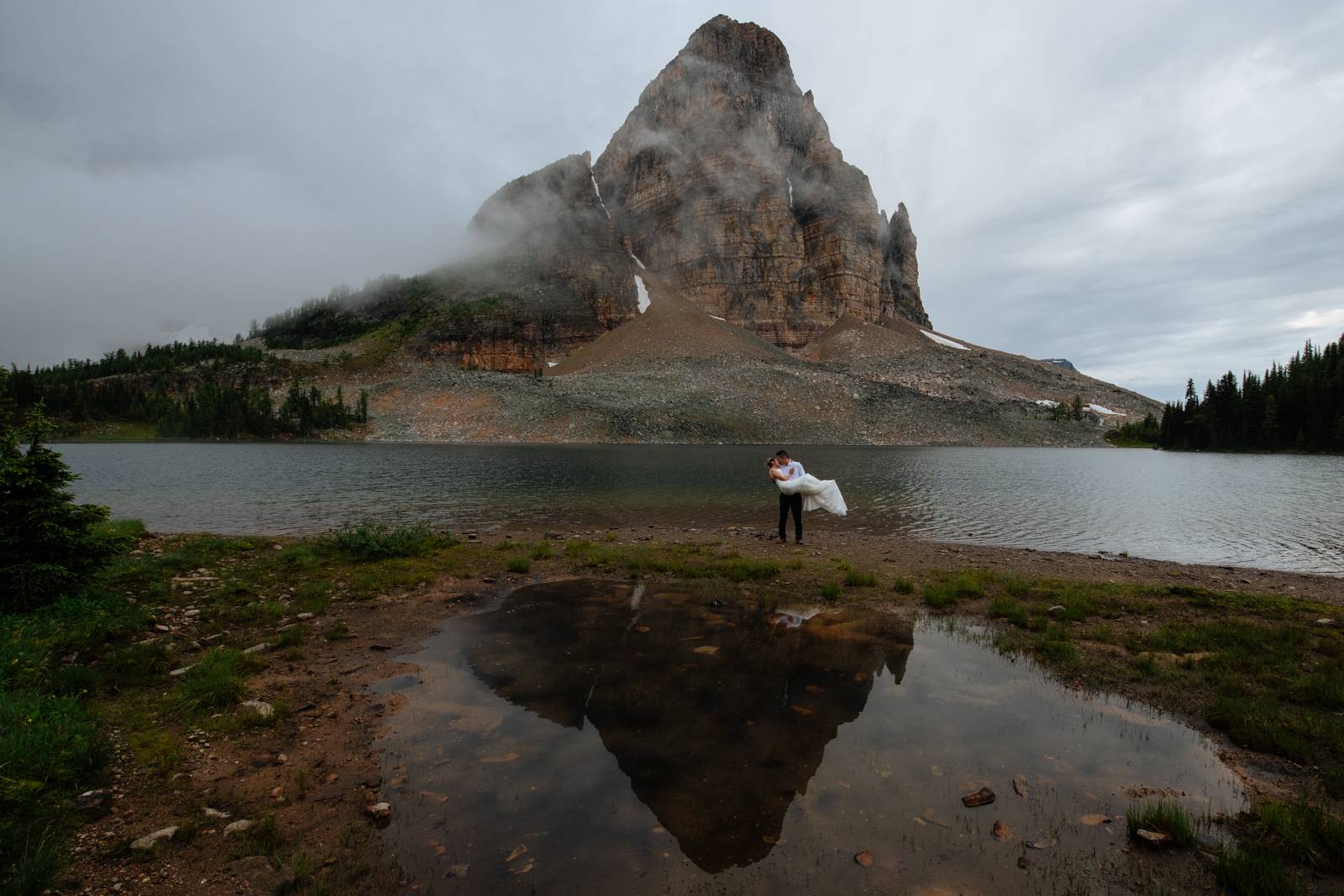 wedding couple by mountain reflection