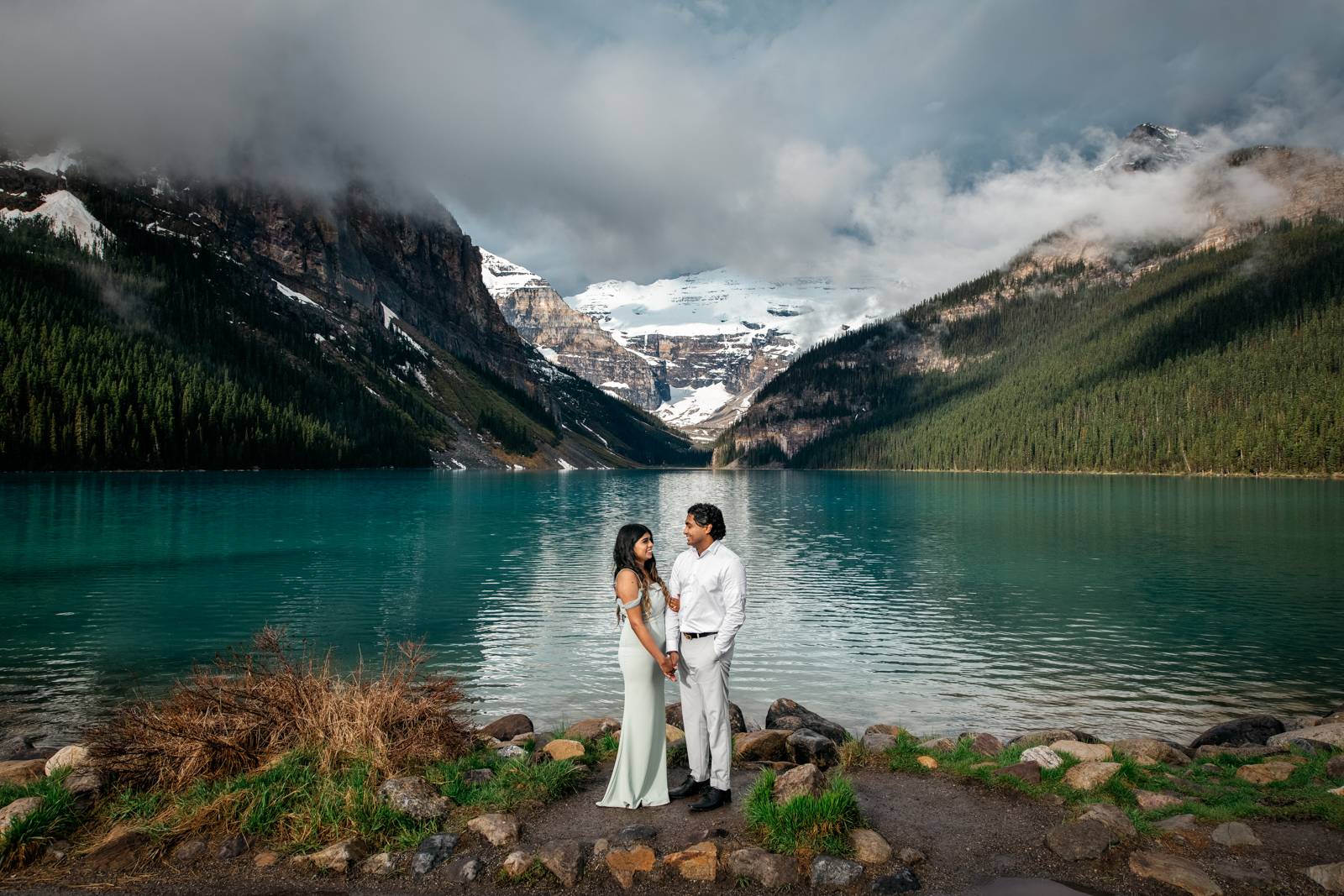 couple holding hands at Lake Louise