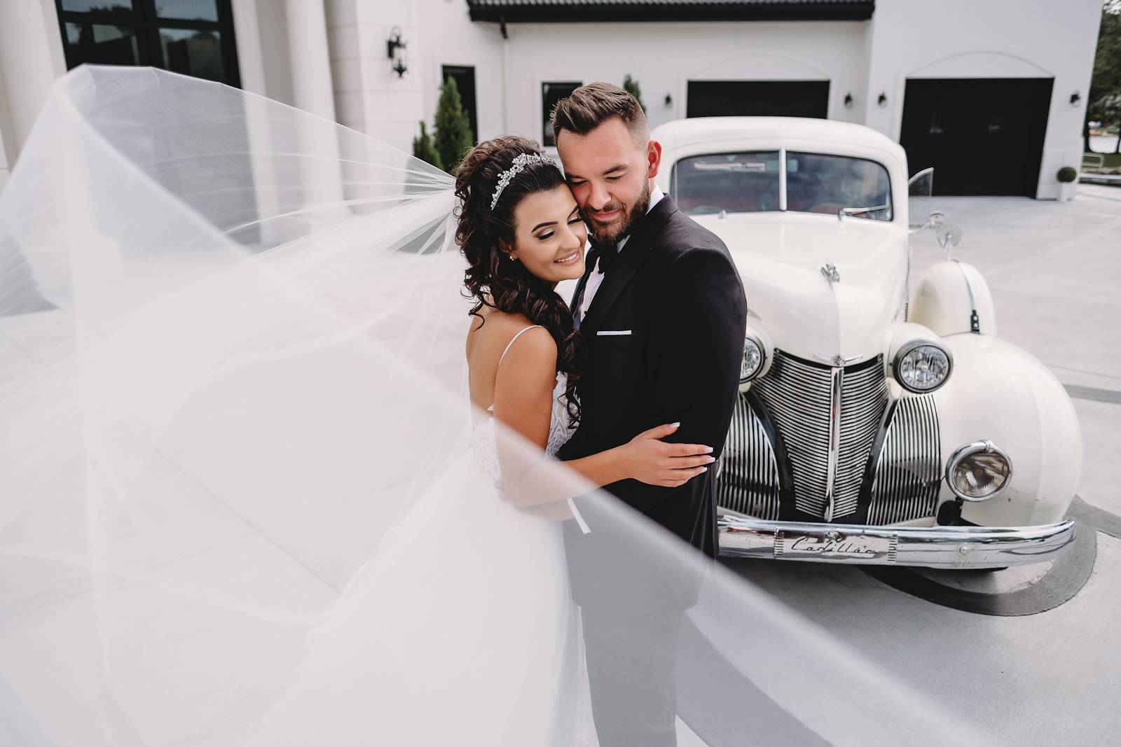 Elegant Wedding Couple with a Vintage Car