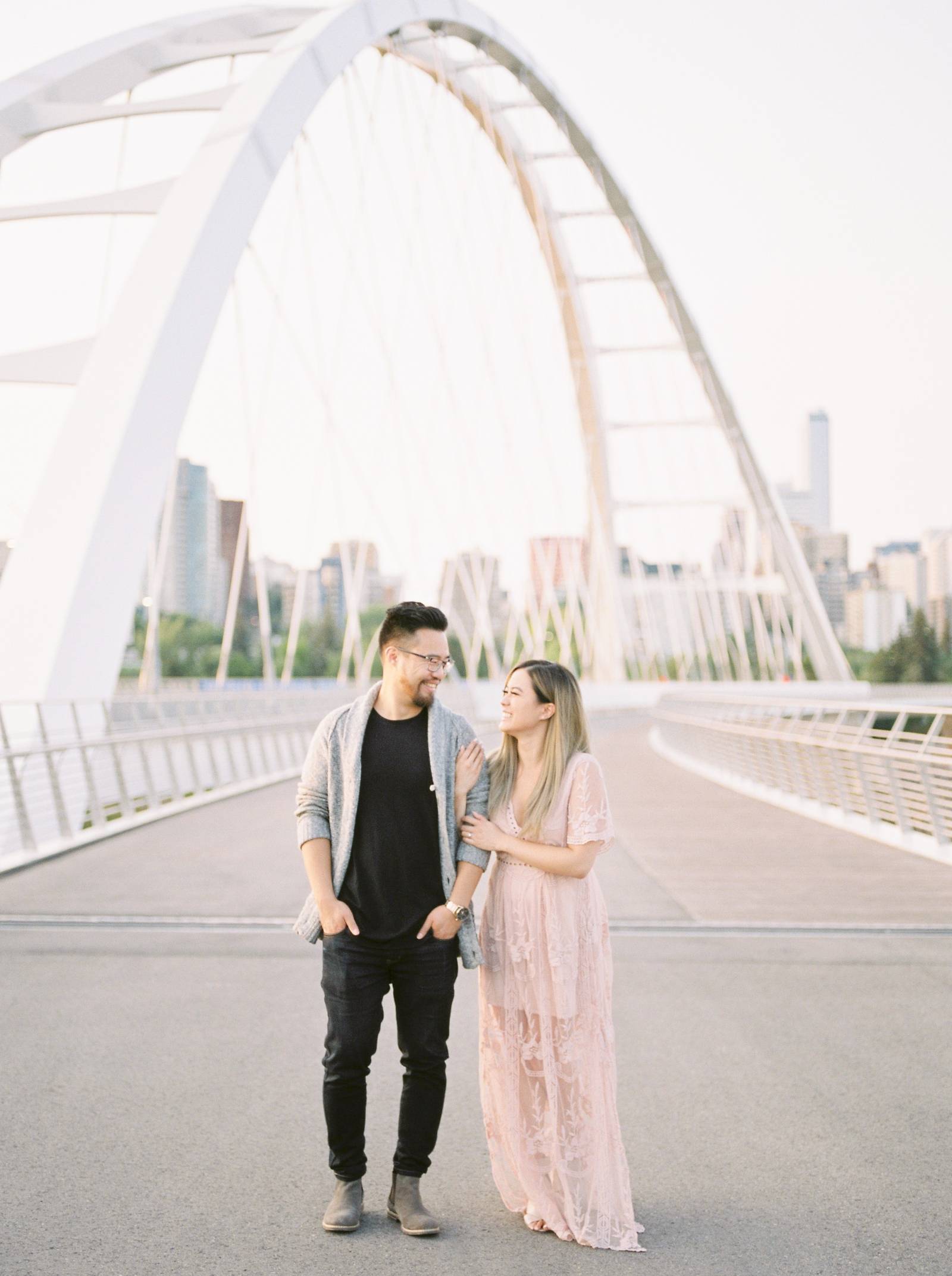 a young engaged couple standing arm and arm on the new Walterdale bride in Edmonton Alberta