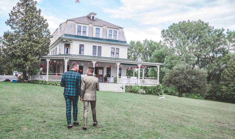 Couple walking toward the Grand Isle Lake House porch after ceremony