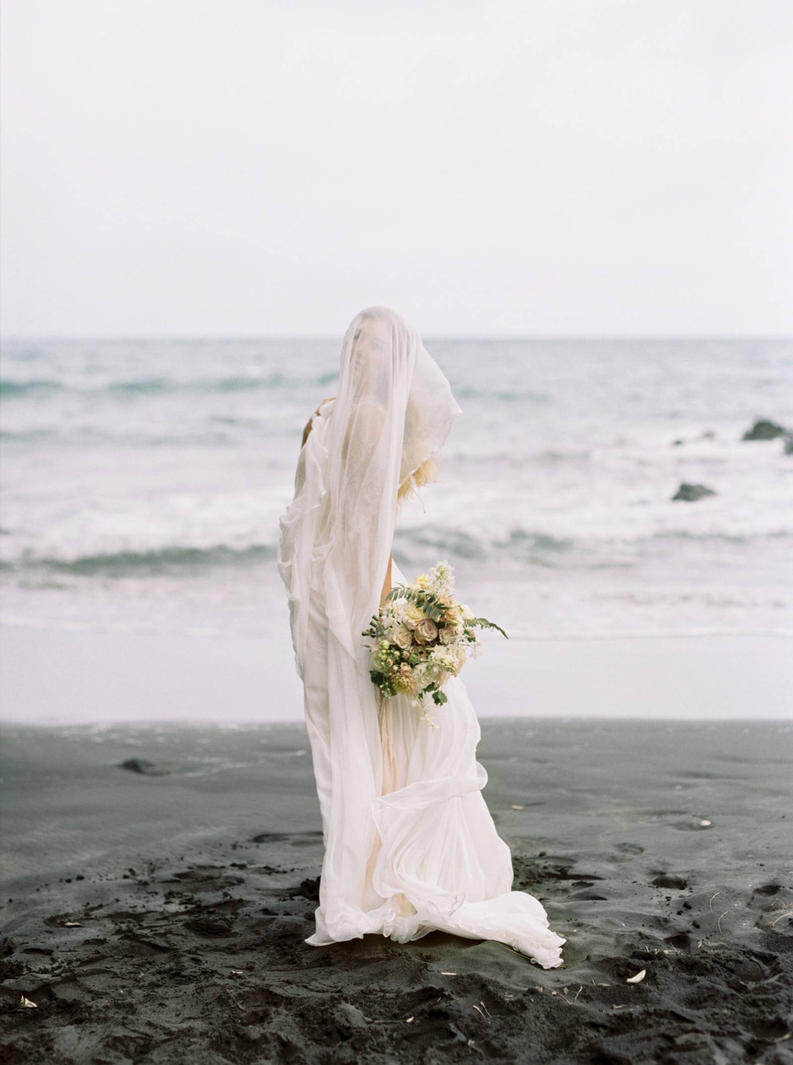 Ethereal bridal shoot on a black sand beach in New Zealand ...
