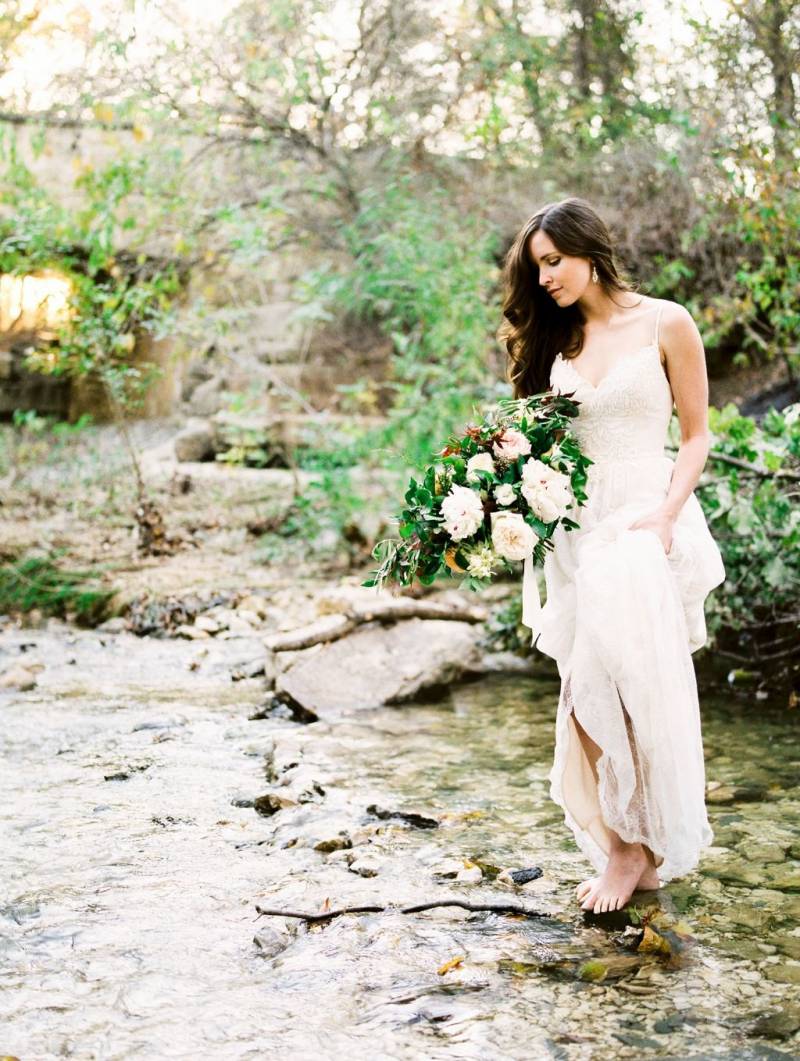 Bride with bouquet in the creek