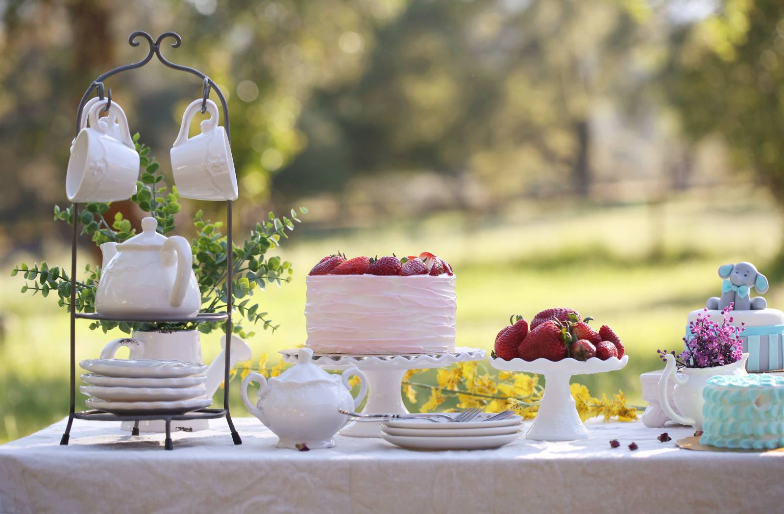 Wedding cake, tea and strawberries.