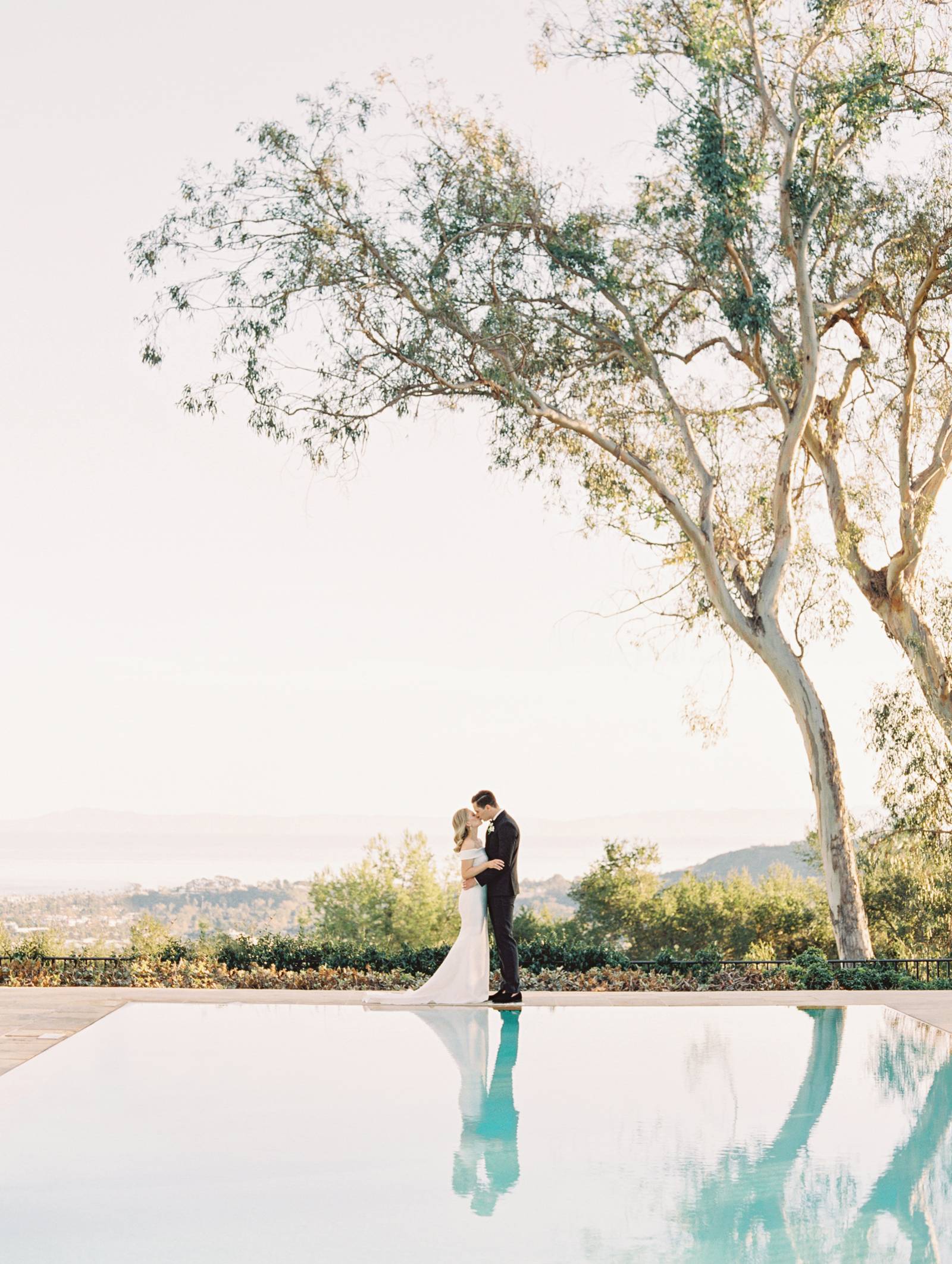 bride, groom, dress, gown, suit, kiss, sunset, pool
