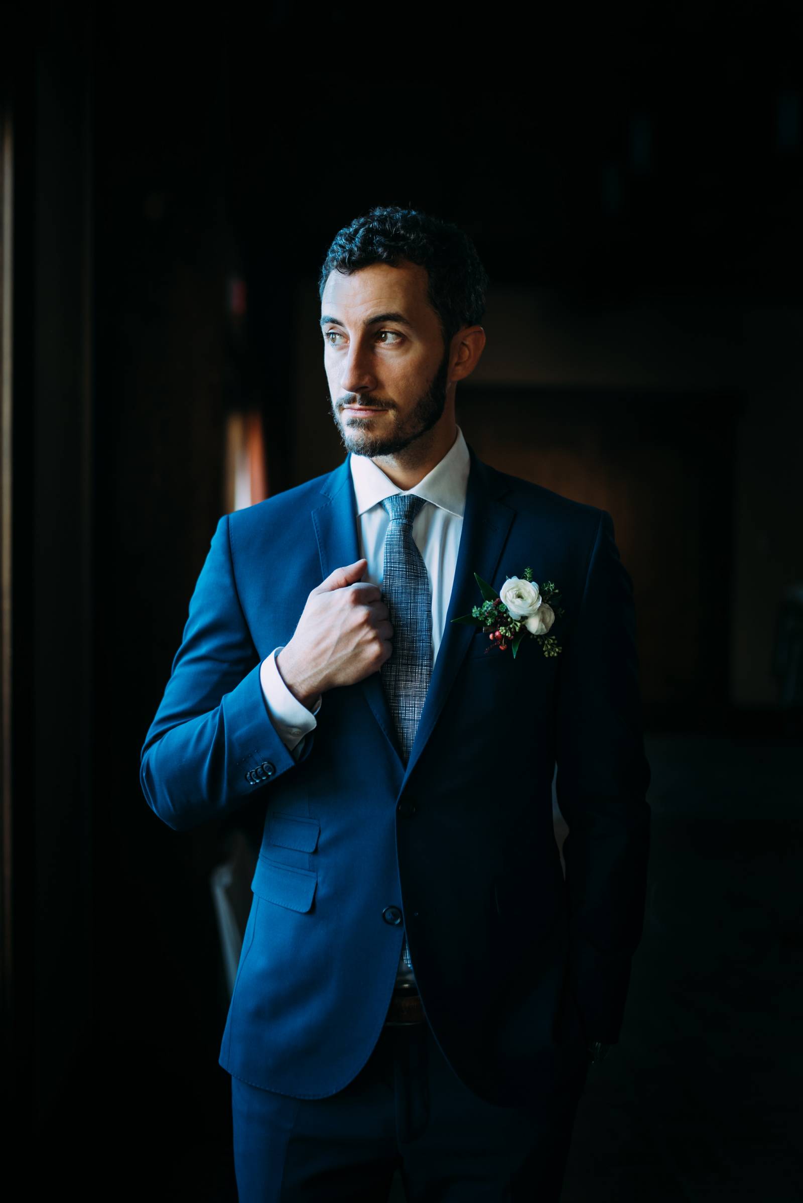 groom in a blue tuxedo