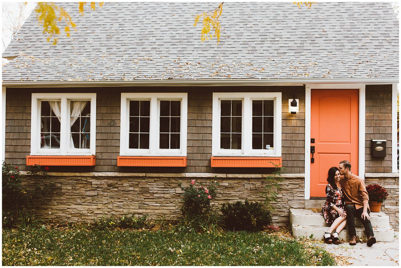 rustic fall engagement picture in front of house captured by Red Aspen Photography
