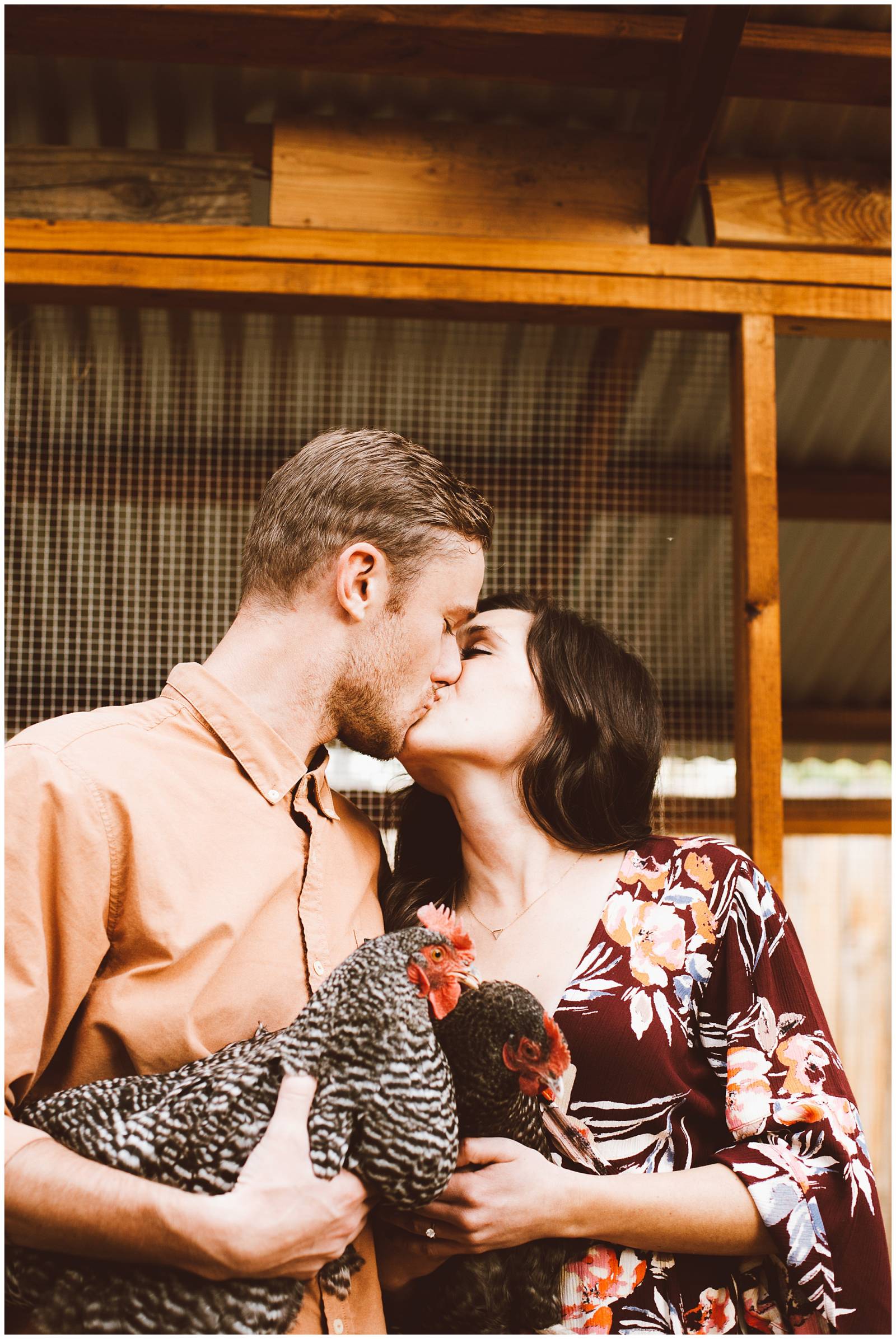 engaged couple kissing holding their chickens | Red Aspen Photography