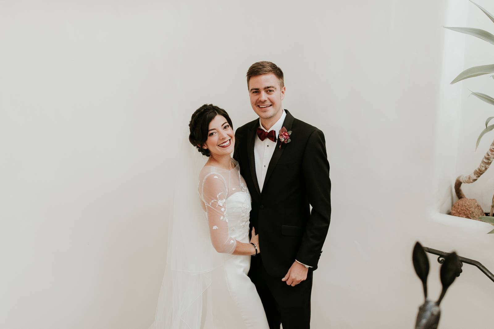 bride and groom smile for picture | bride wearing an Enzoani wedding gown