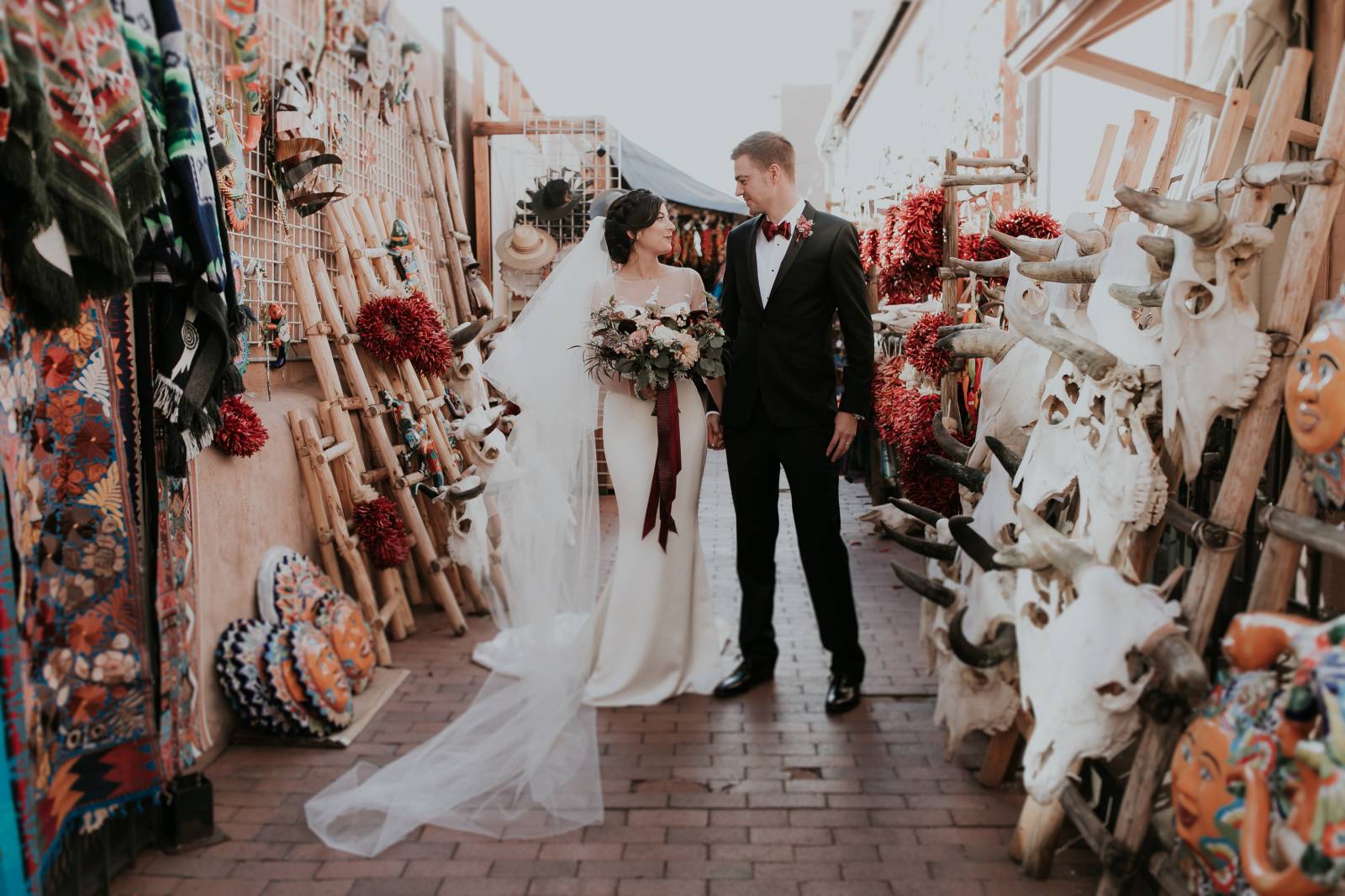 bride and groom posing in downtown Santa Fe market