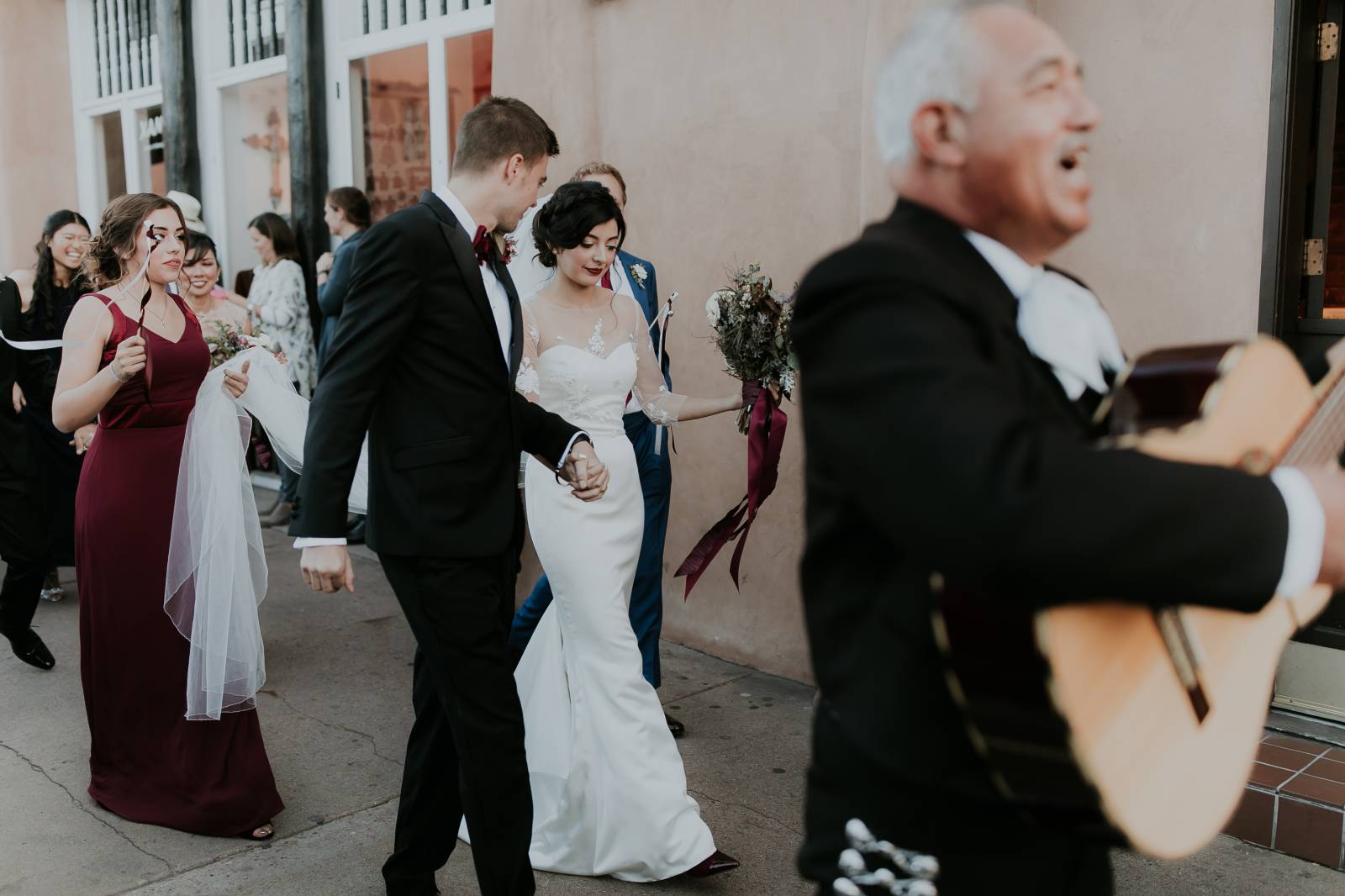 mariachi band leading the bride and groom around the block