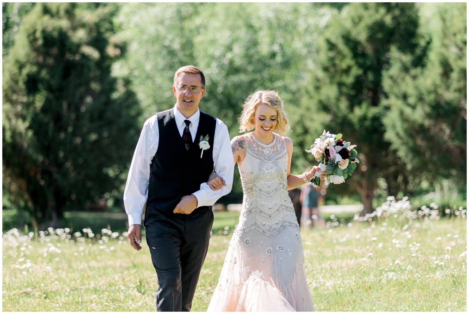 father walking bride down Utah ranch wedding aisle | bride wearing a BHLDN dress