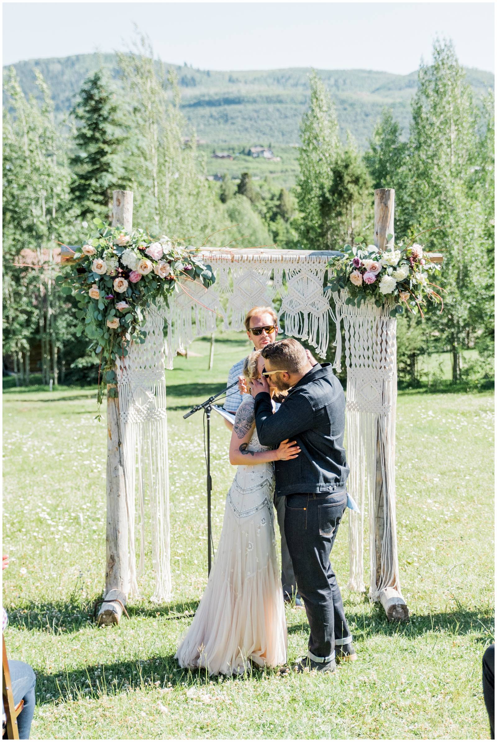 bride and groom kissing at ceremony