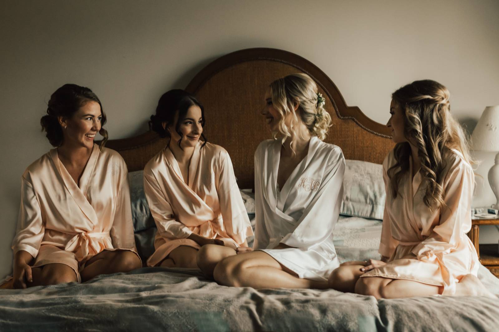 bride and bridesmaids in robes hanging out before wedding ceremony captured by Nomad by NK