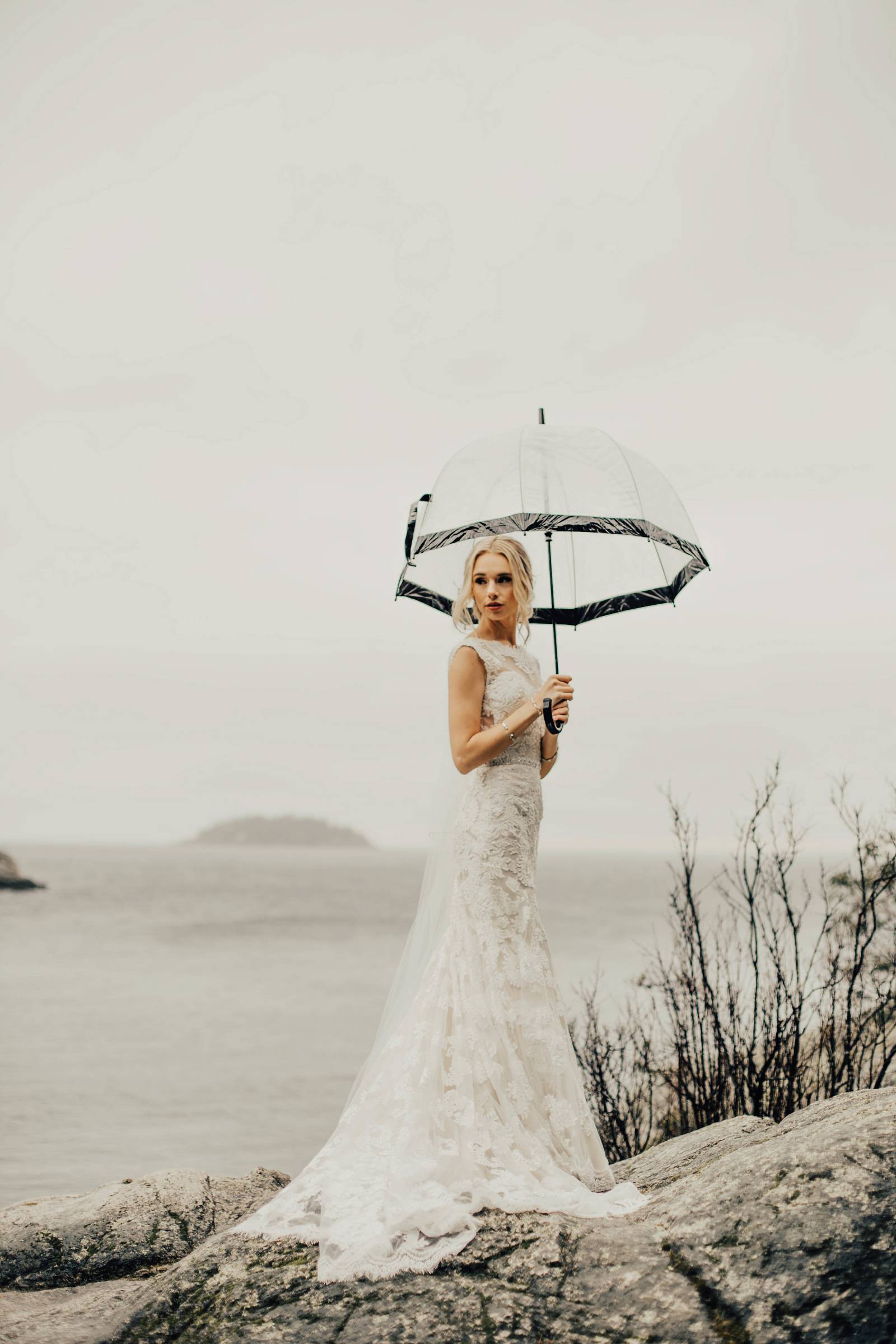 bride under umbrella at Grouse Mountain lake
