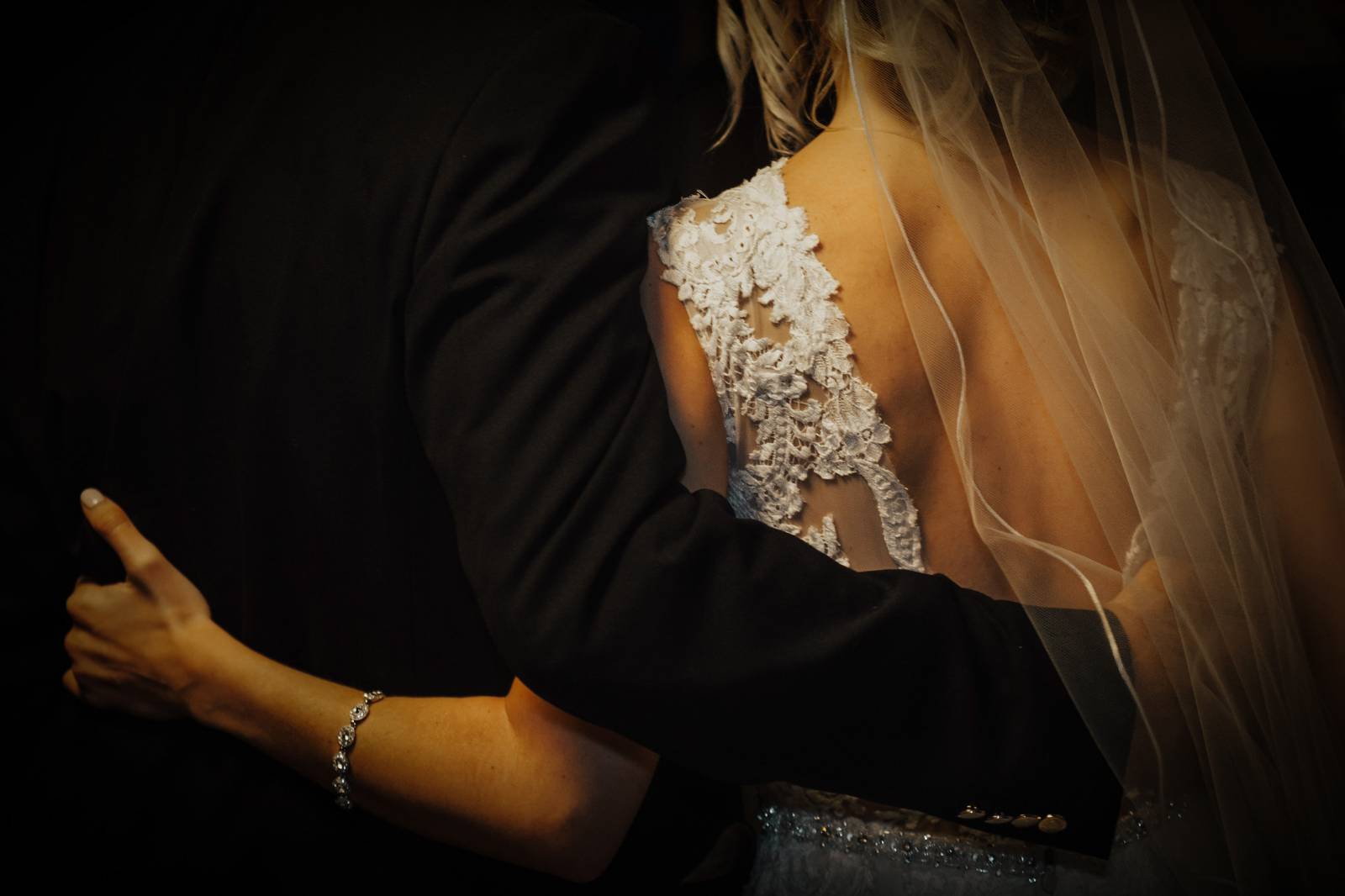 photo of back of father of the bride with bride