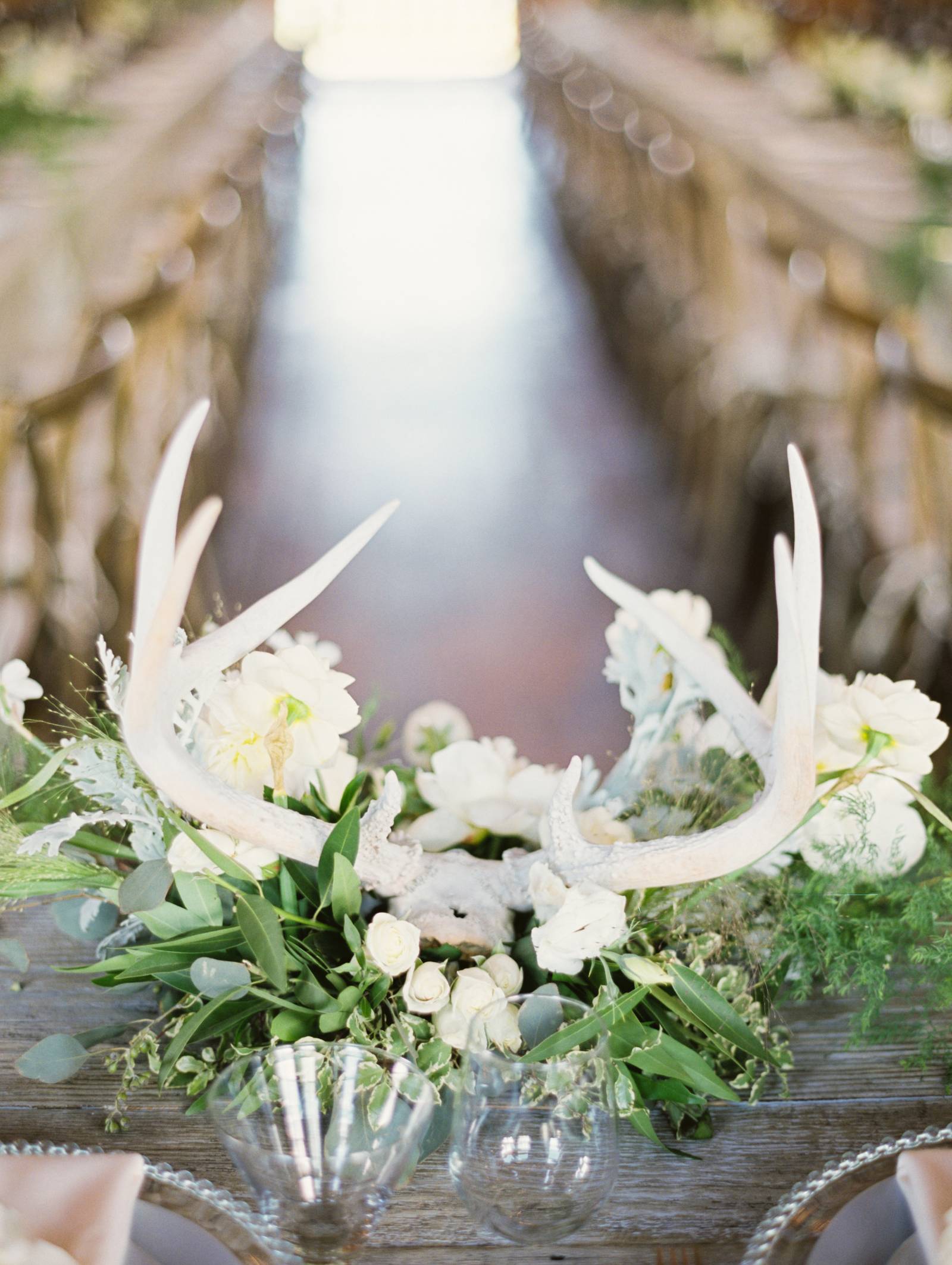 antlers and flower centerpiece | rustic barn wedding reception