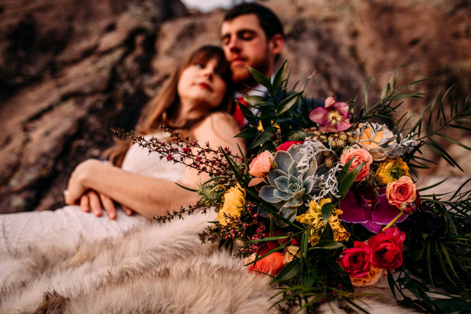 portrait of bride and groom | colorful spring wedding bouquet is focus of photo