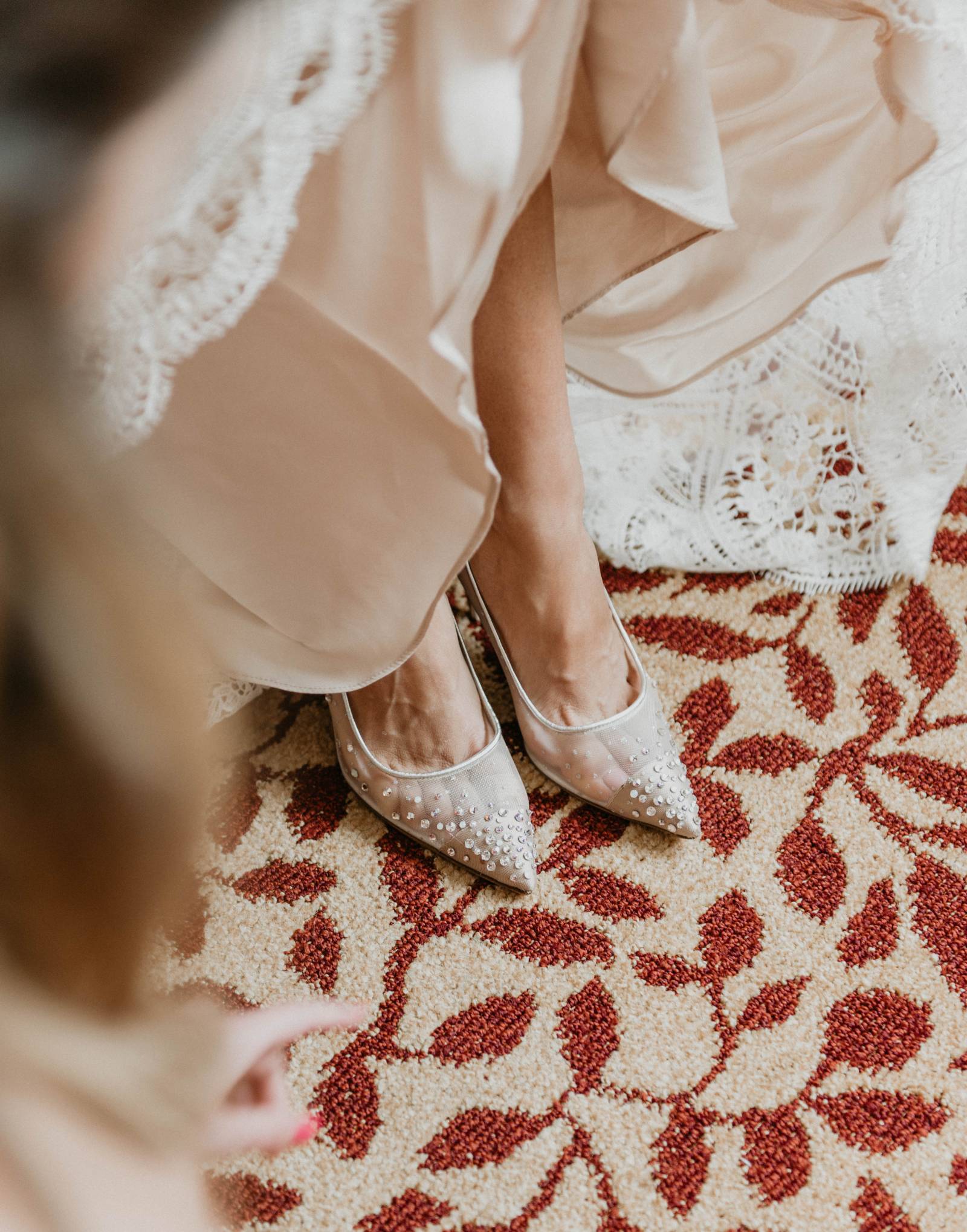 bride showing off her pearly elegant wedding high heels
