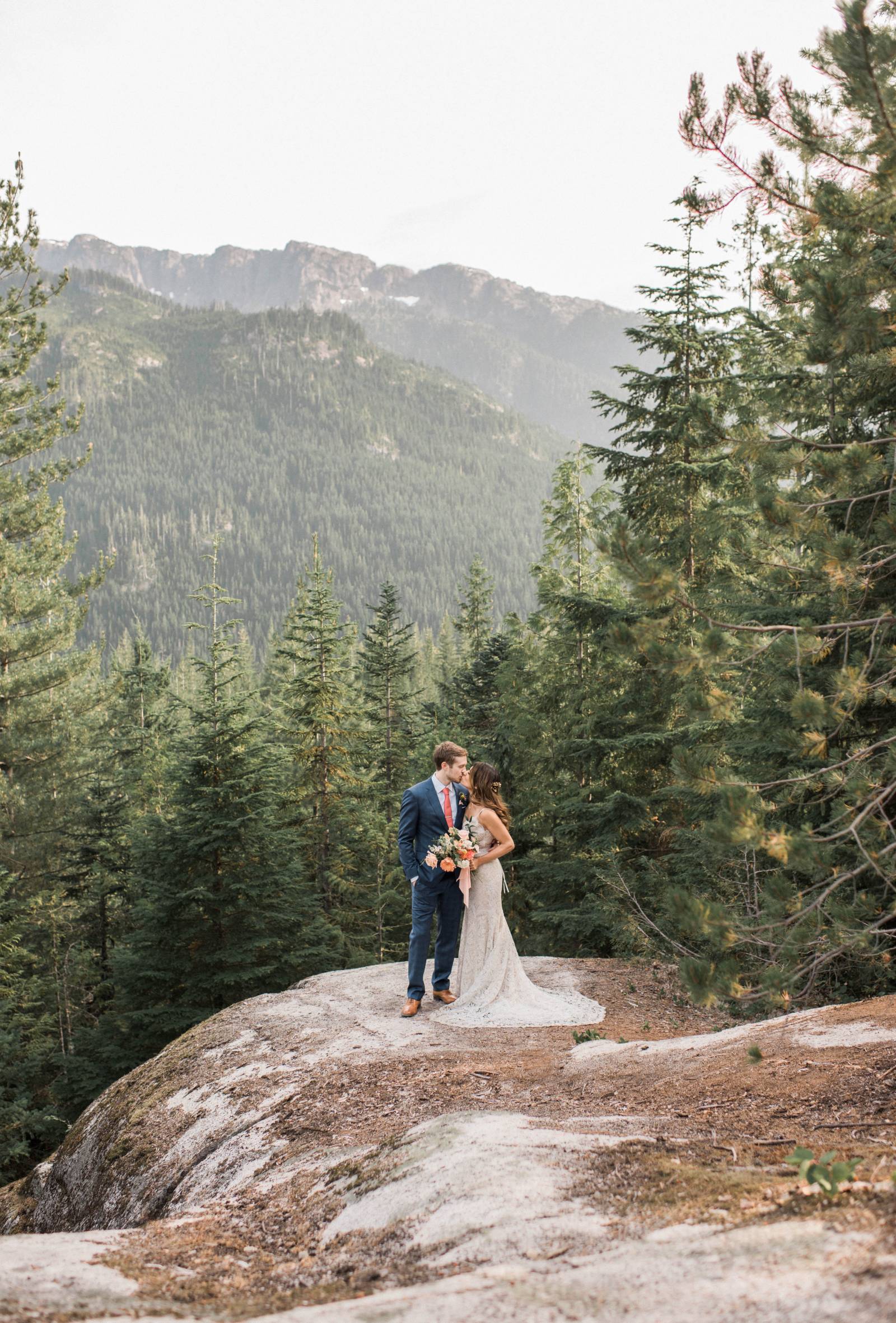 portrait of bride and groom on top of British Columbia mountains