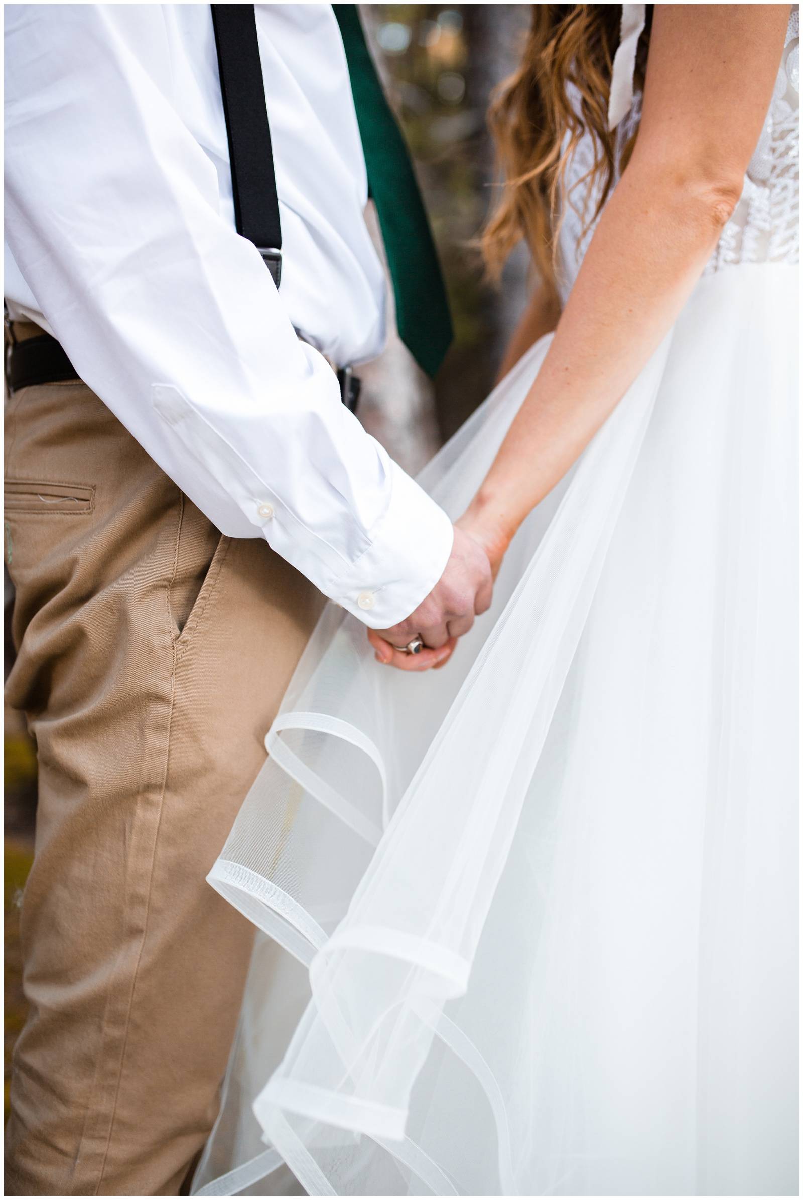 bride and groom holding hands during Colorado mountain elopement