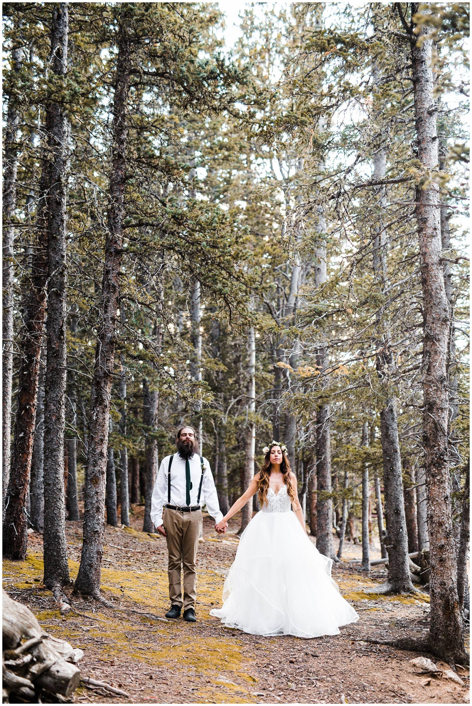 portrait of bride and groom in mountain forest in Colorado