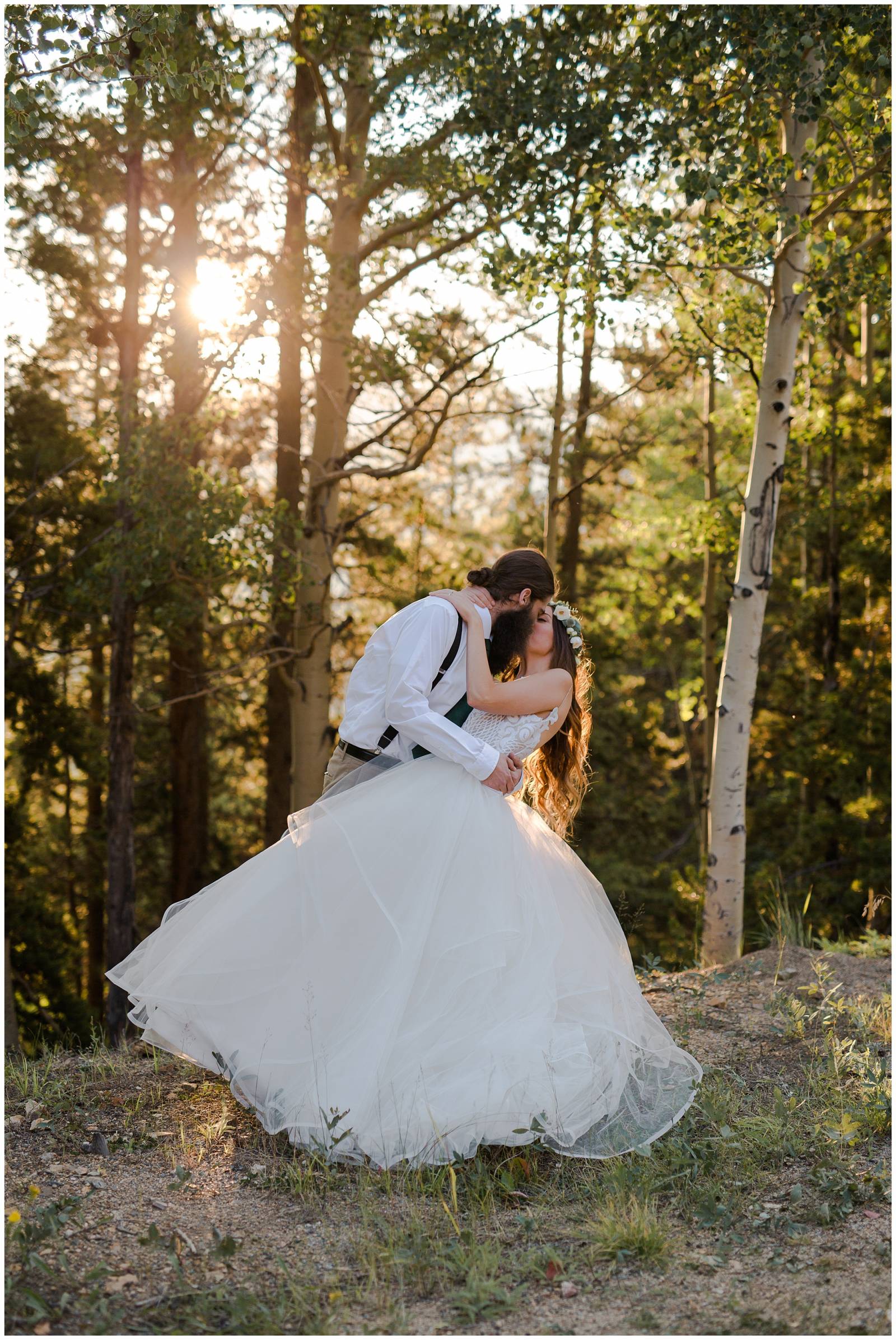 bride and groom kissing in Colorado aspen trees during sunset