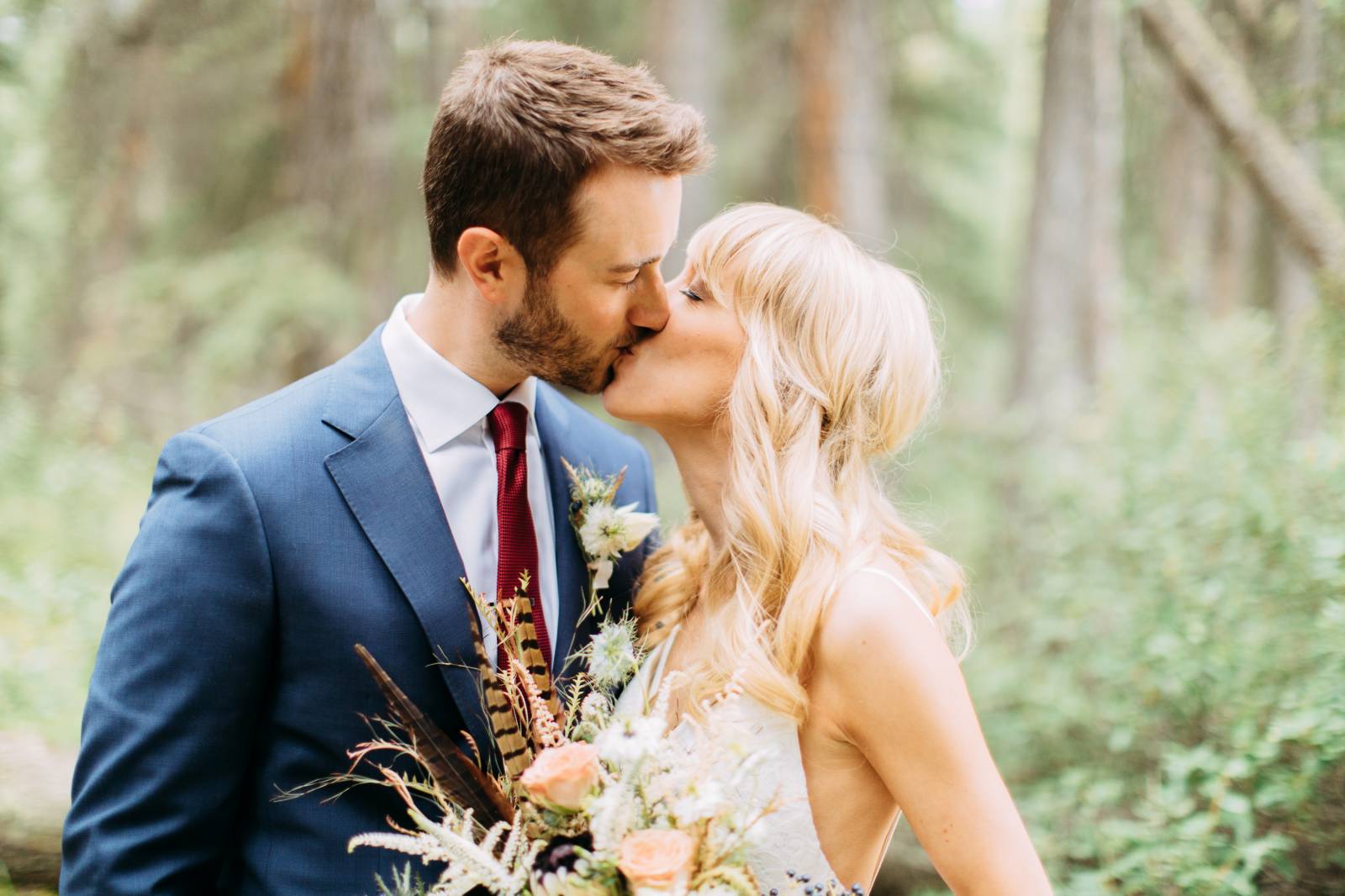 summer wedding in Banff | wedding portrait of bride and groom kissing