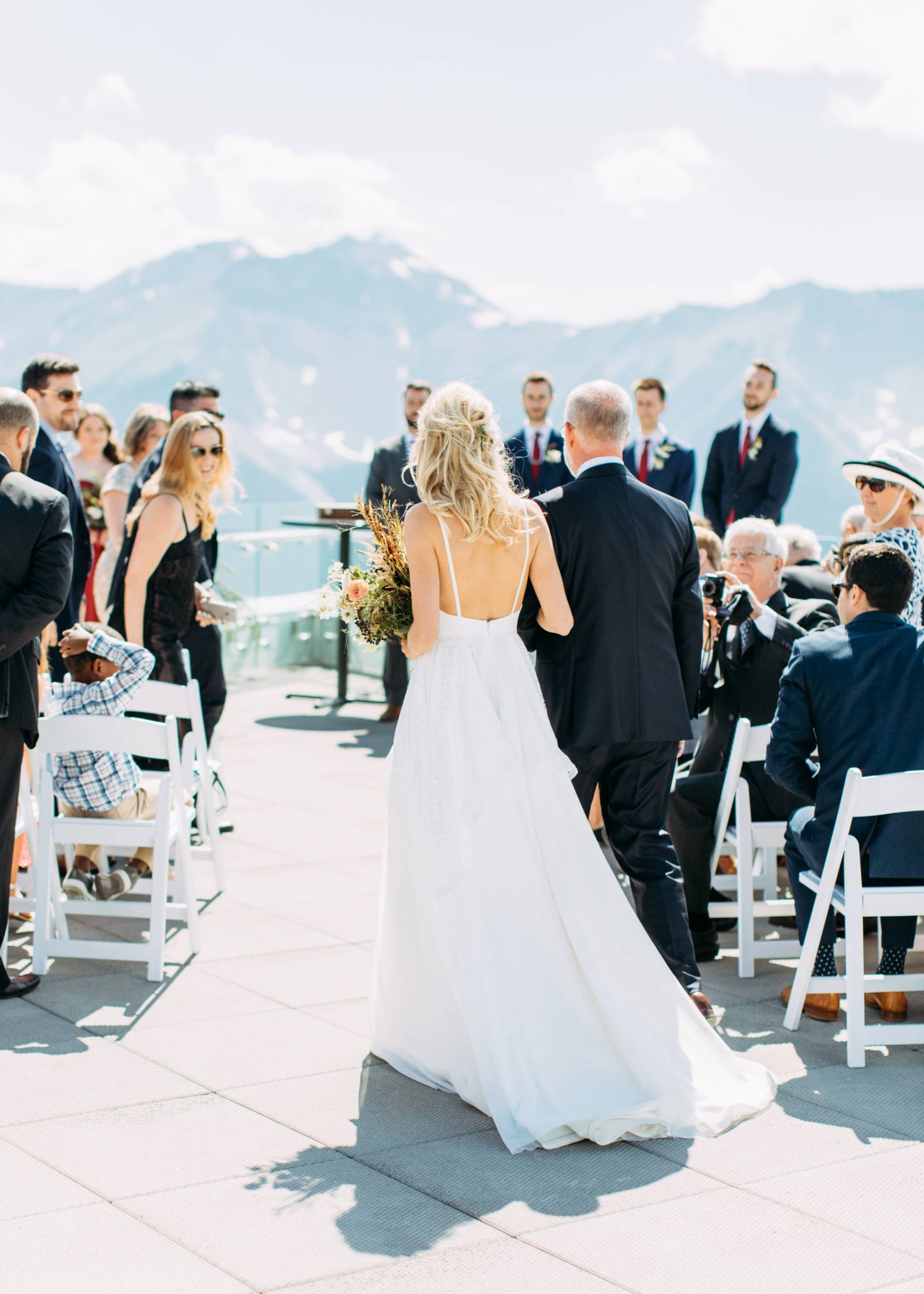 father walking bride down the aisle at mountain top wedding ceremony