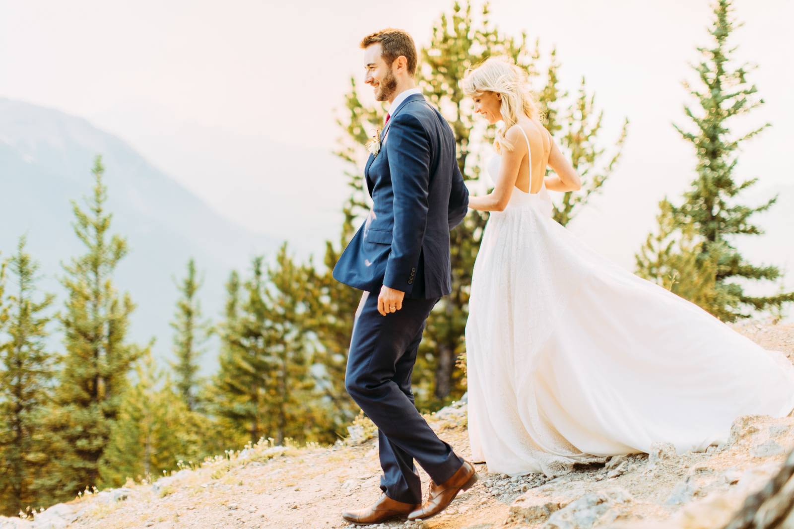 groom leading bride down the mountain