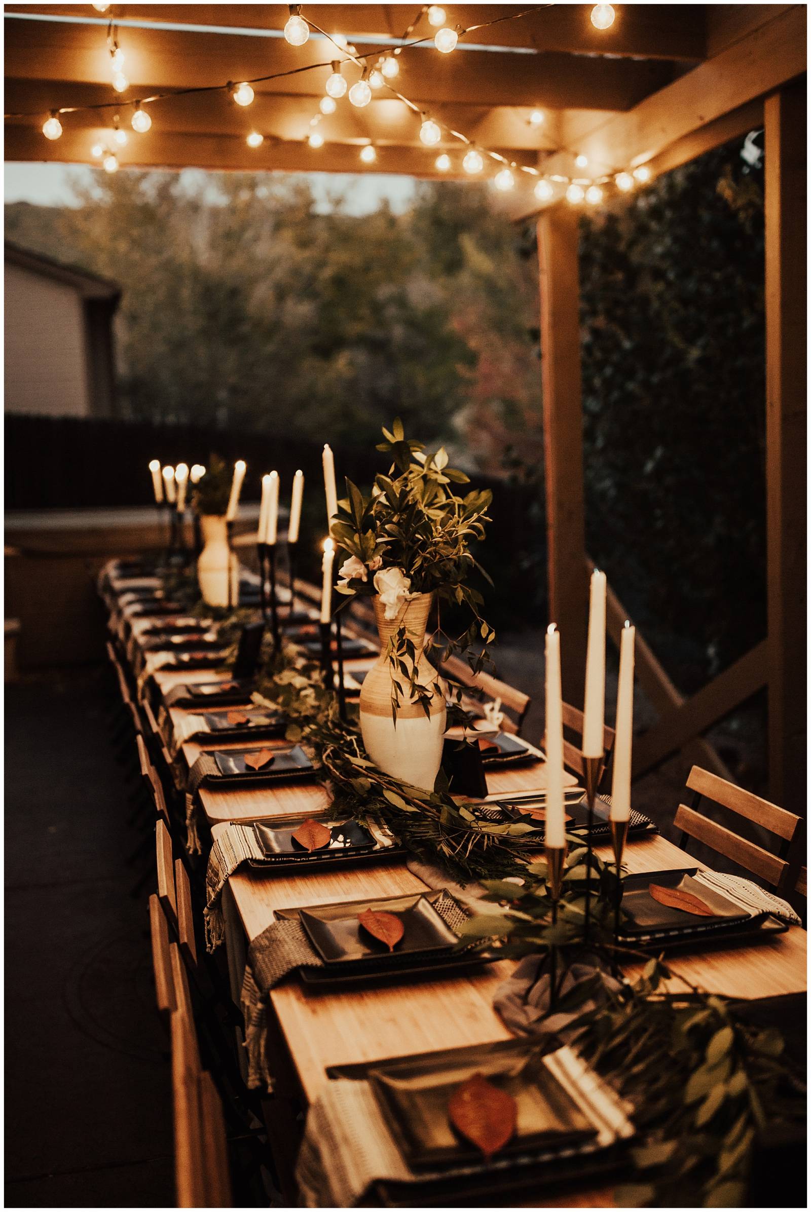 natural outdoor wedding reception inspiration | wood table and chairs with black plates and green le