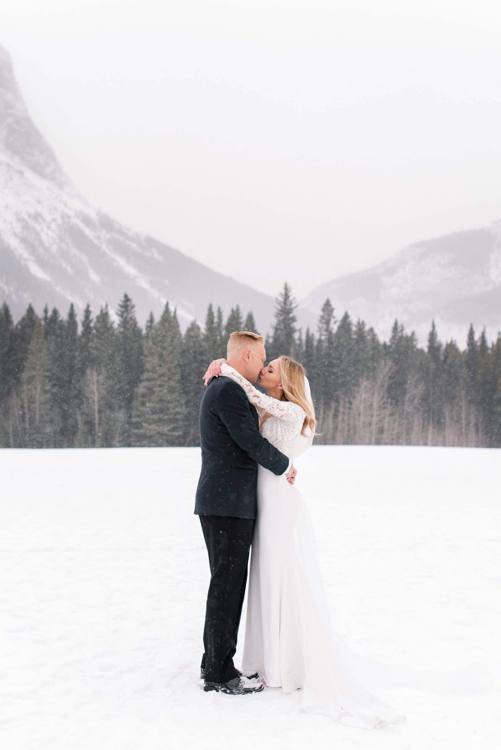 bride and groom kissing in the snow | Canmore winter wedding inspiration