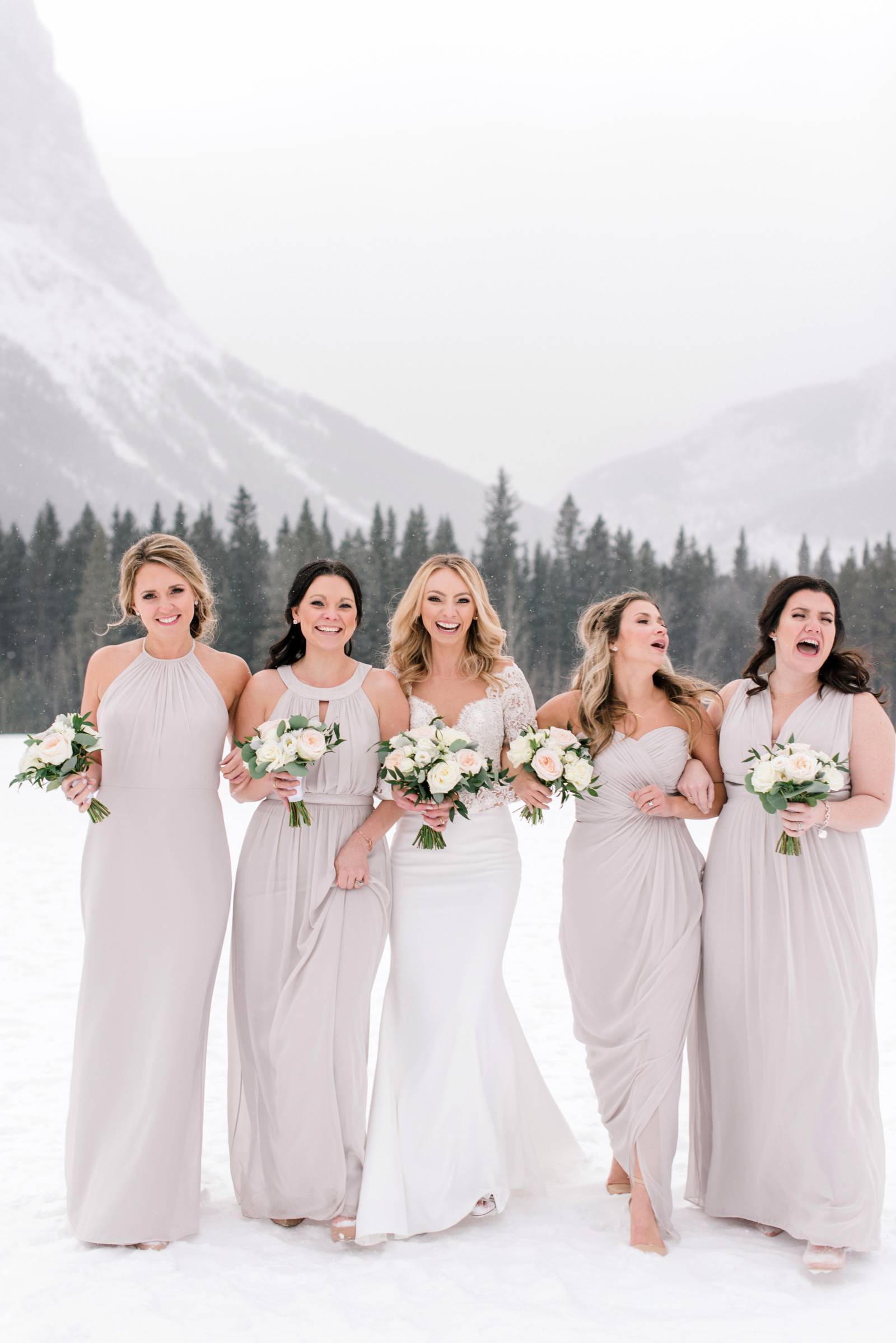 bride with bridesmaids in beautiful mismatched dresses | Canmore winter wedding inspiration