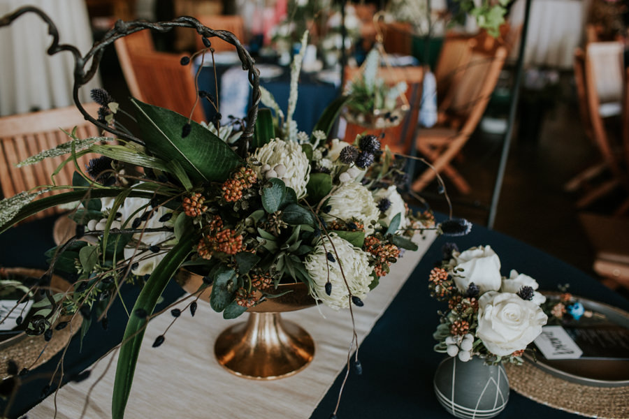 stunning green floral wedding centerpieces in gold vases