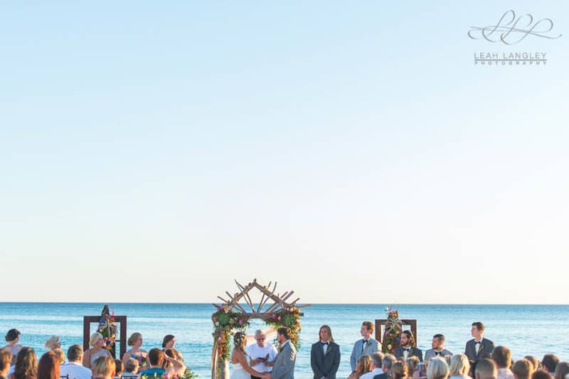 couple getting married on the beach in their wedding ceremony