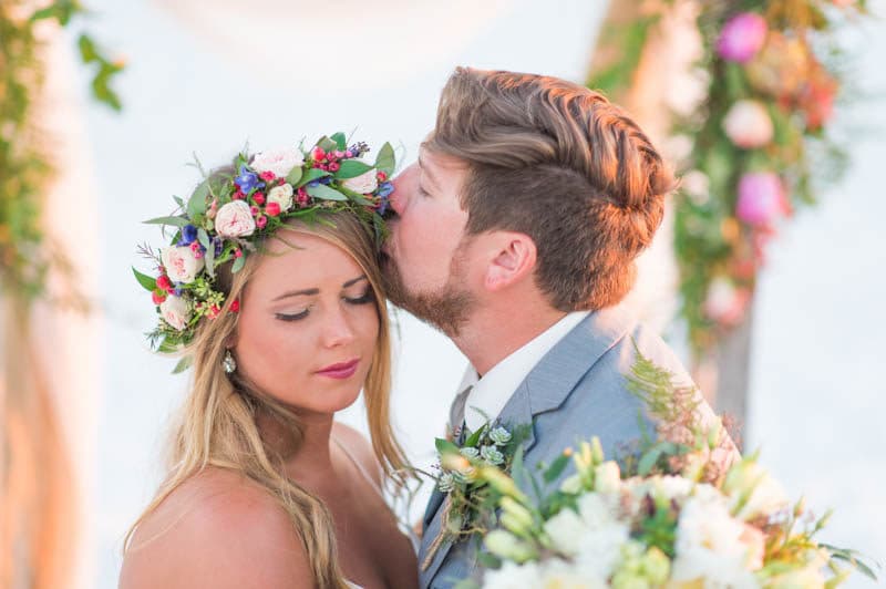 groom kiss brides forehead on wedding day