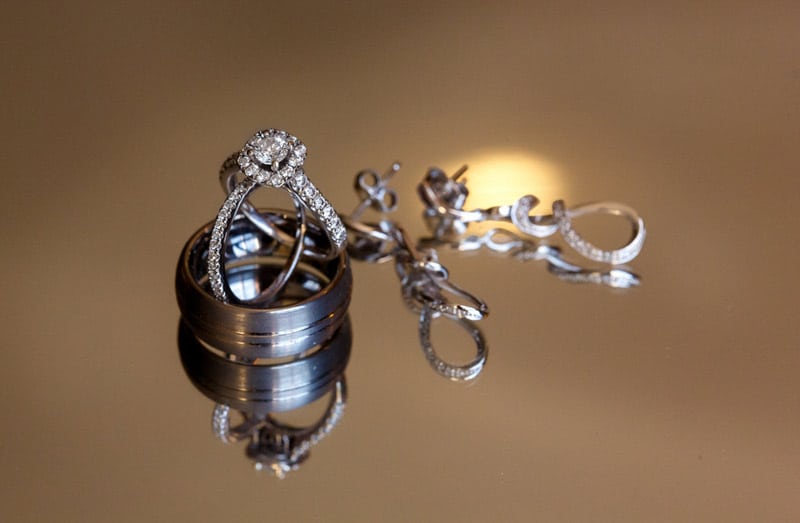 wedding band and engagement ring nestled in men's wedding band