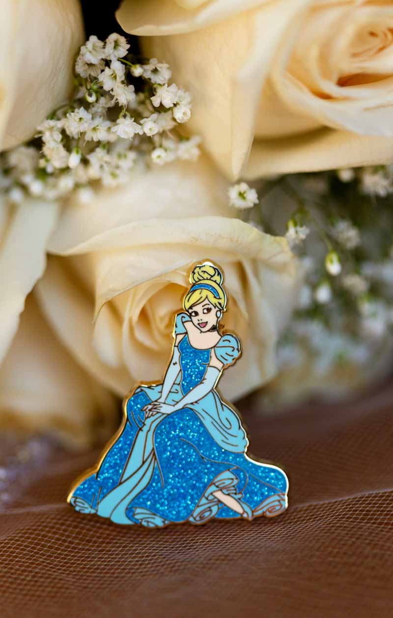Cinderella pin in front of bridal bouquet