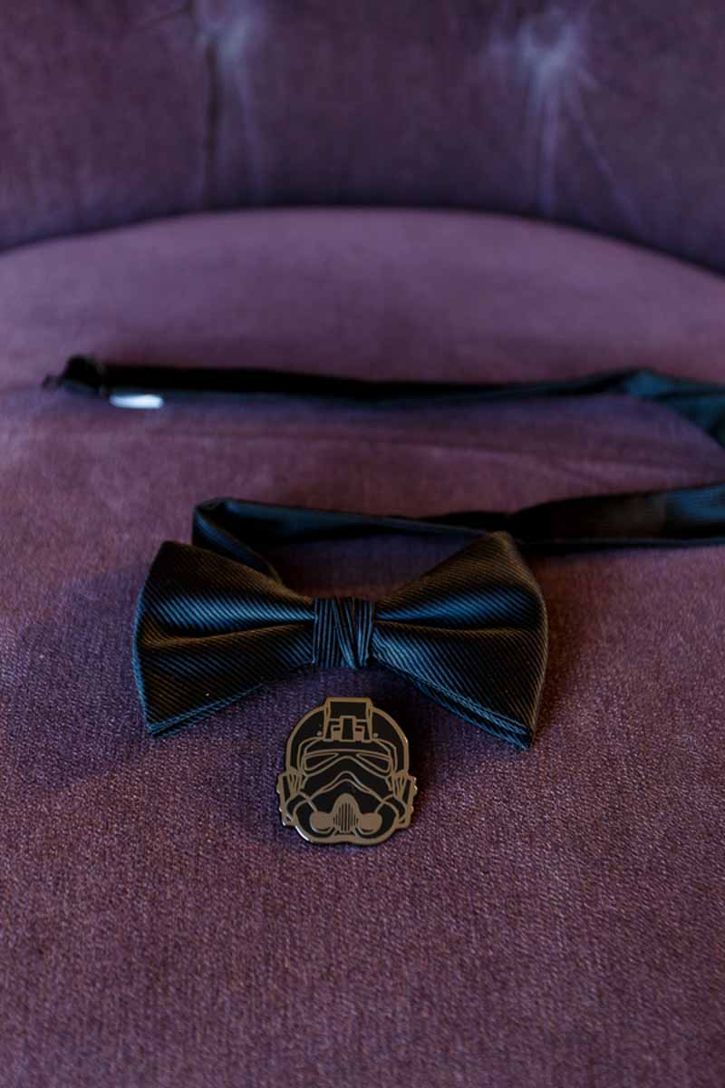 black bowtie and Darth Vader pin on purple chair