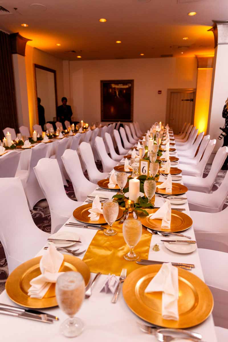 gold wedding chargers on reception table