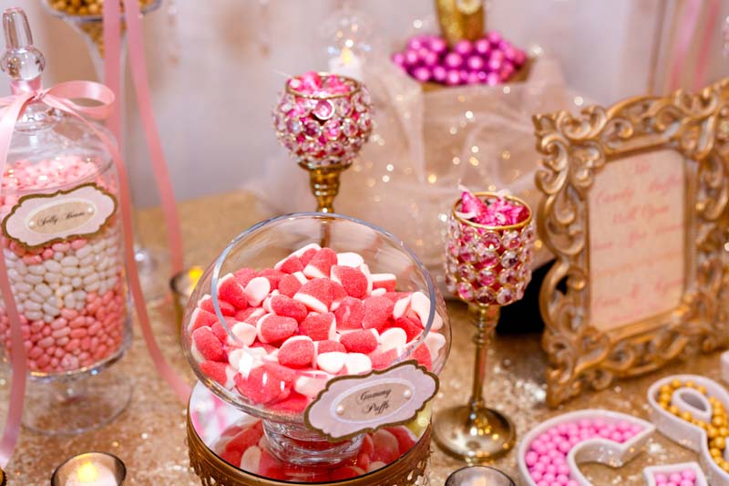 pink and white gummies on candy table