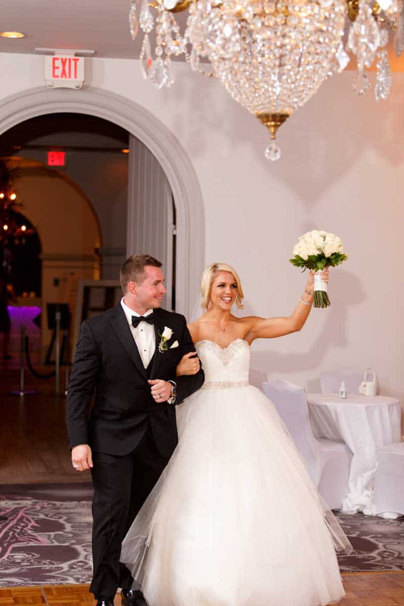 couple walking into wedding reception