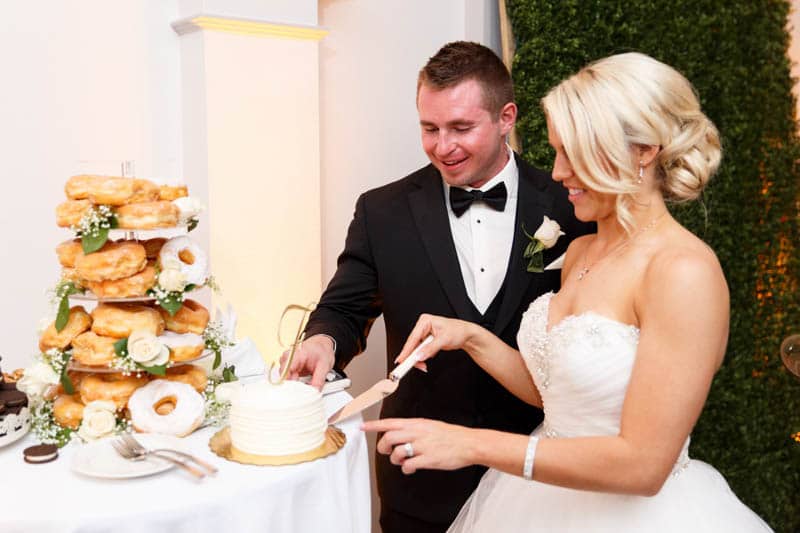 bride and groom cutting wedding cake