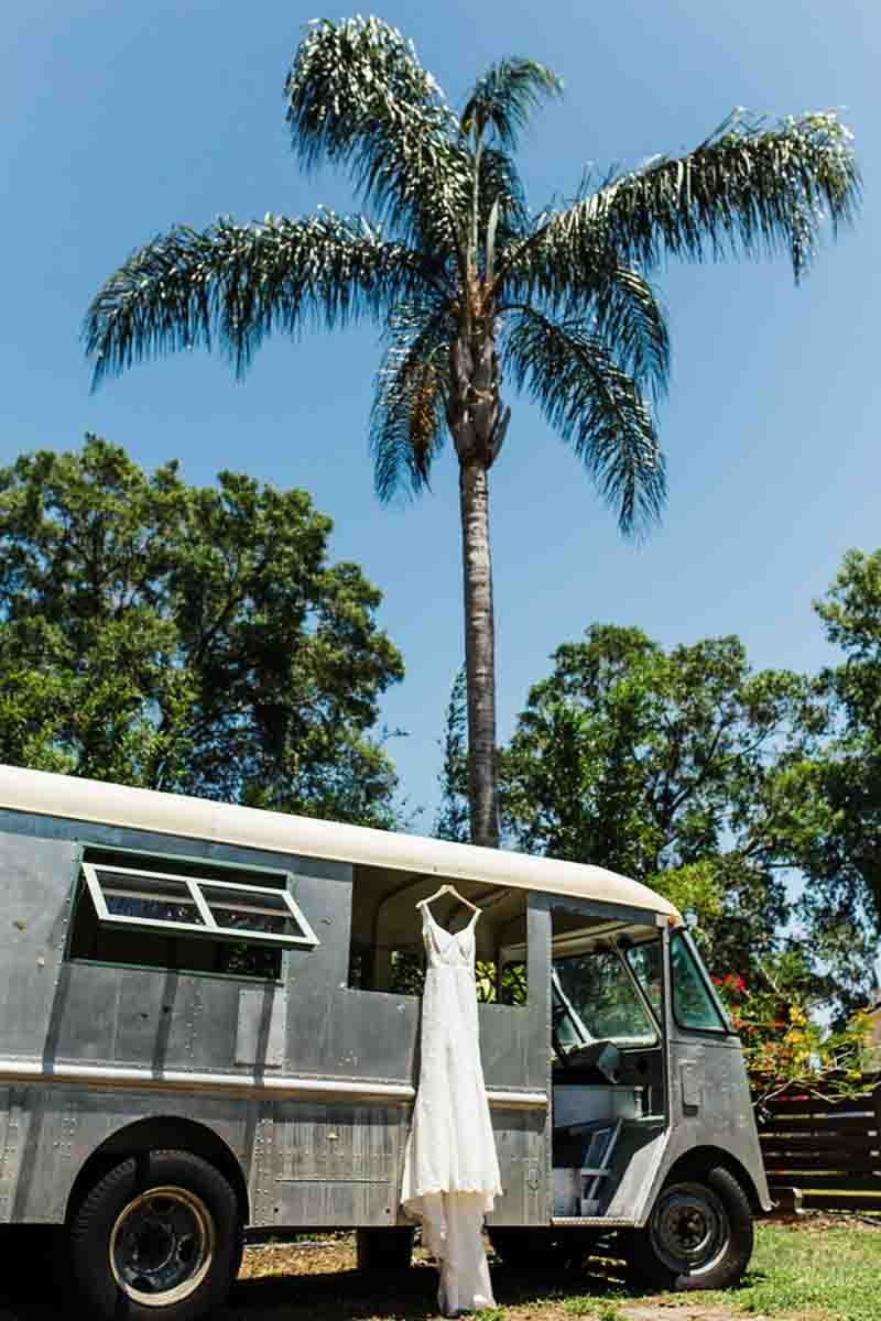wedding dress hanging from old van