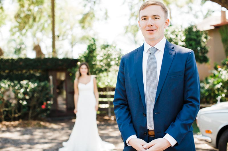groom waiting for bride for first look