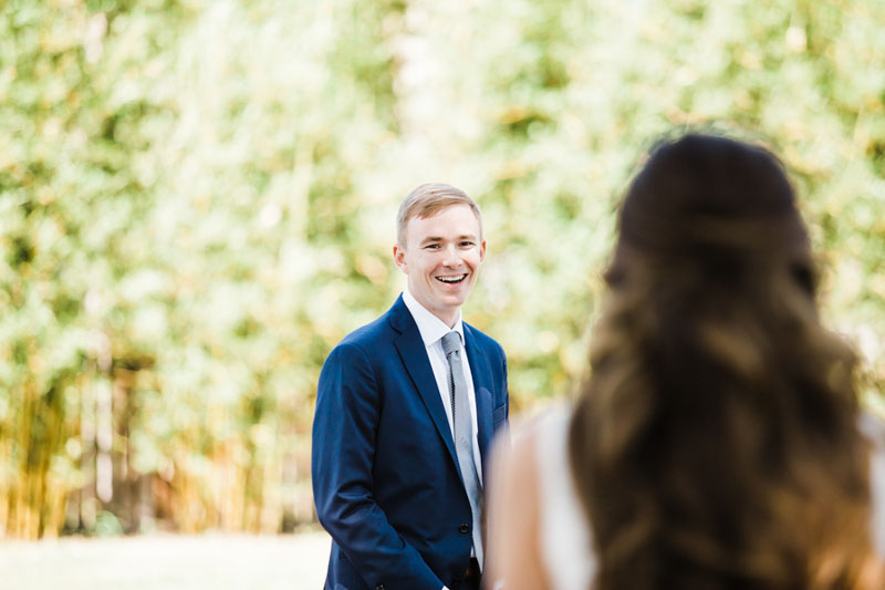 groom smiling when seeing bride for first time