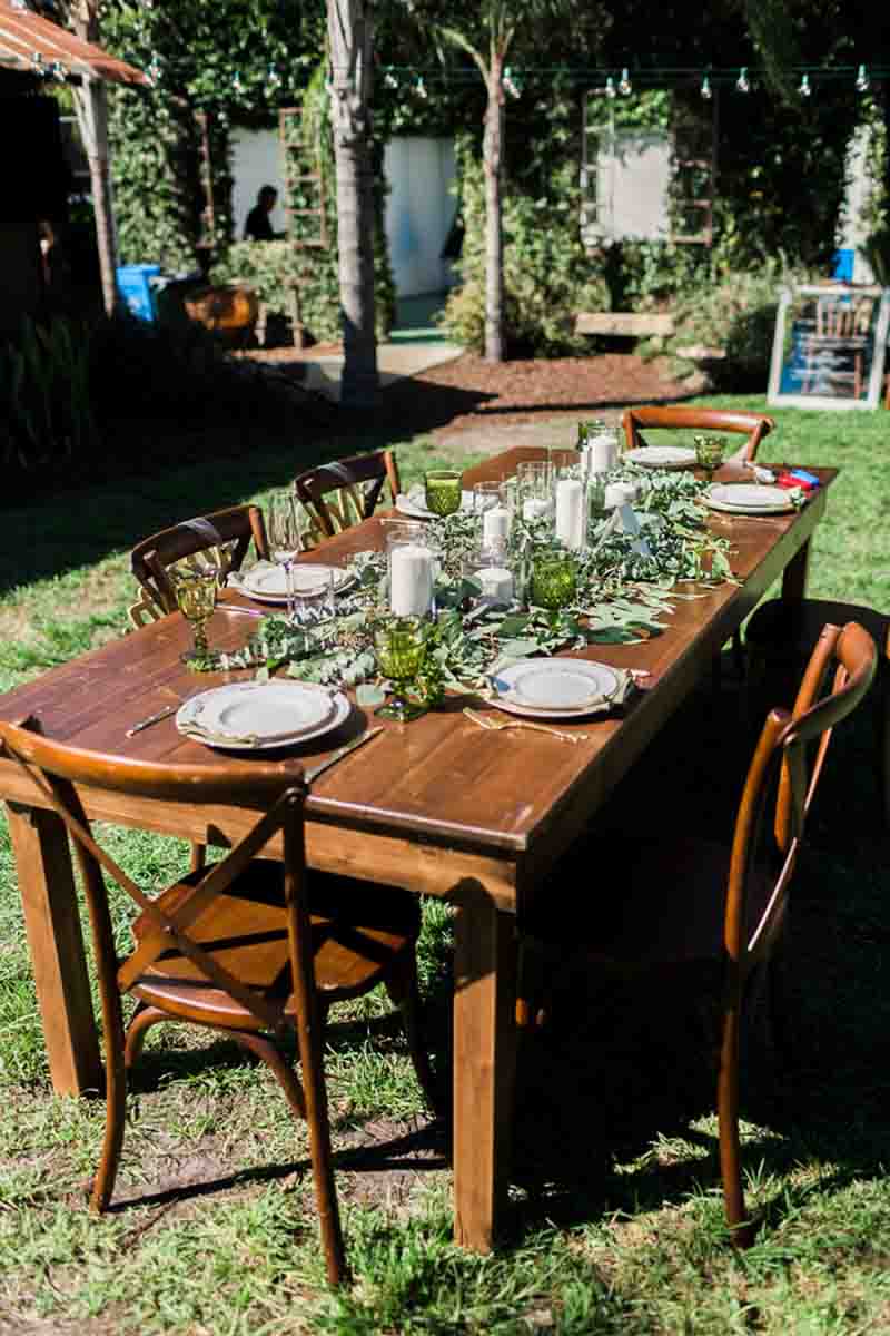 wedding reception farm table with candles and garland