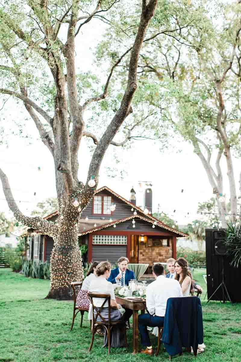 wedding guests sitting at table outside