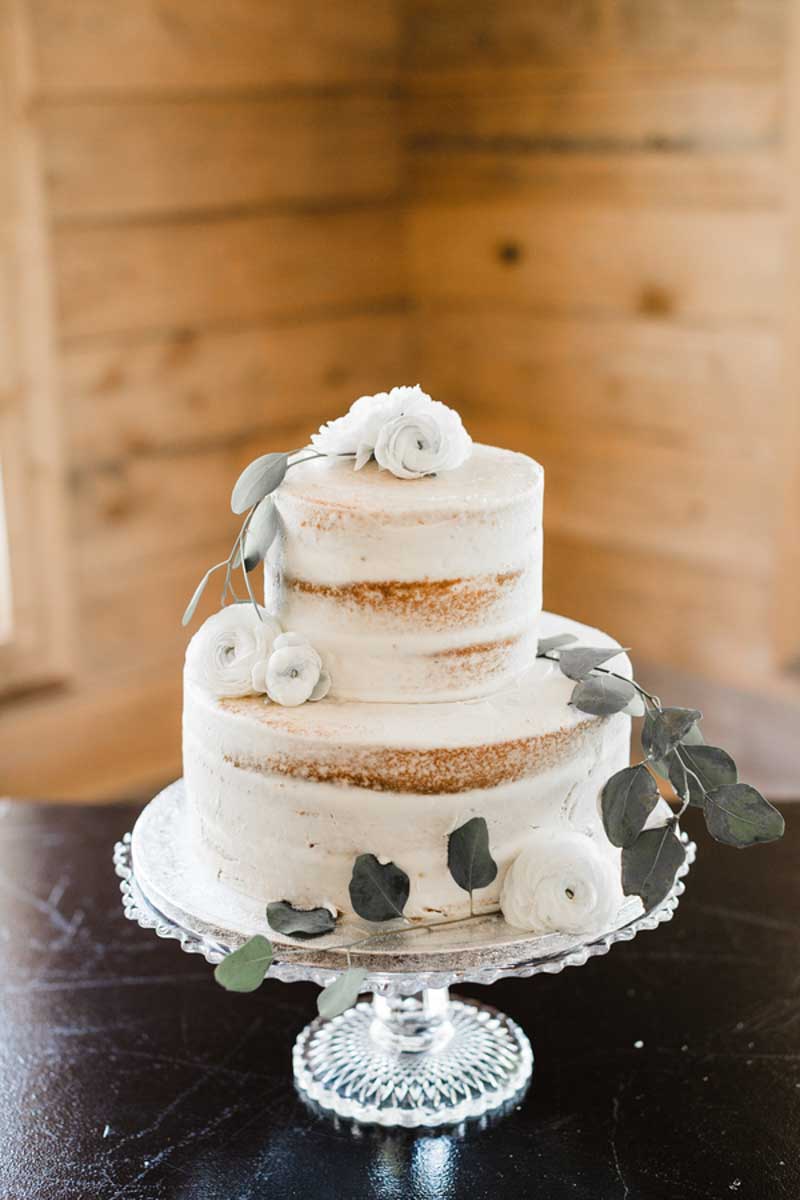 semi naked wedding cake with white flowers