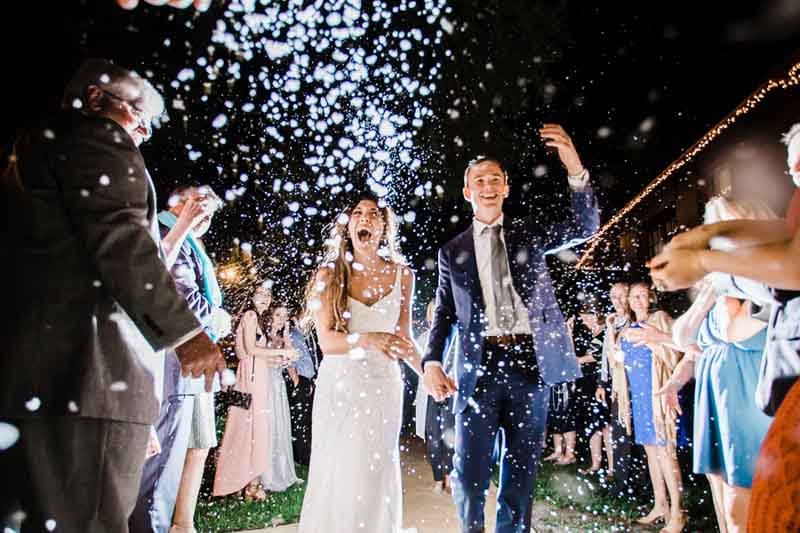 wedding guests throwing confetti for grand exit